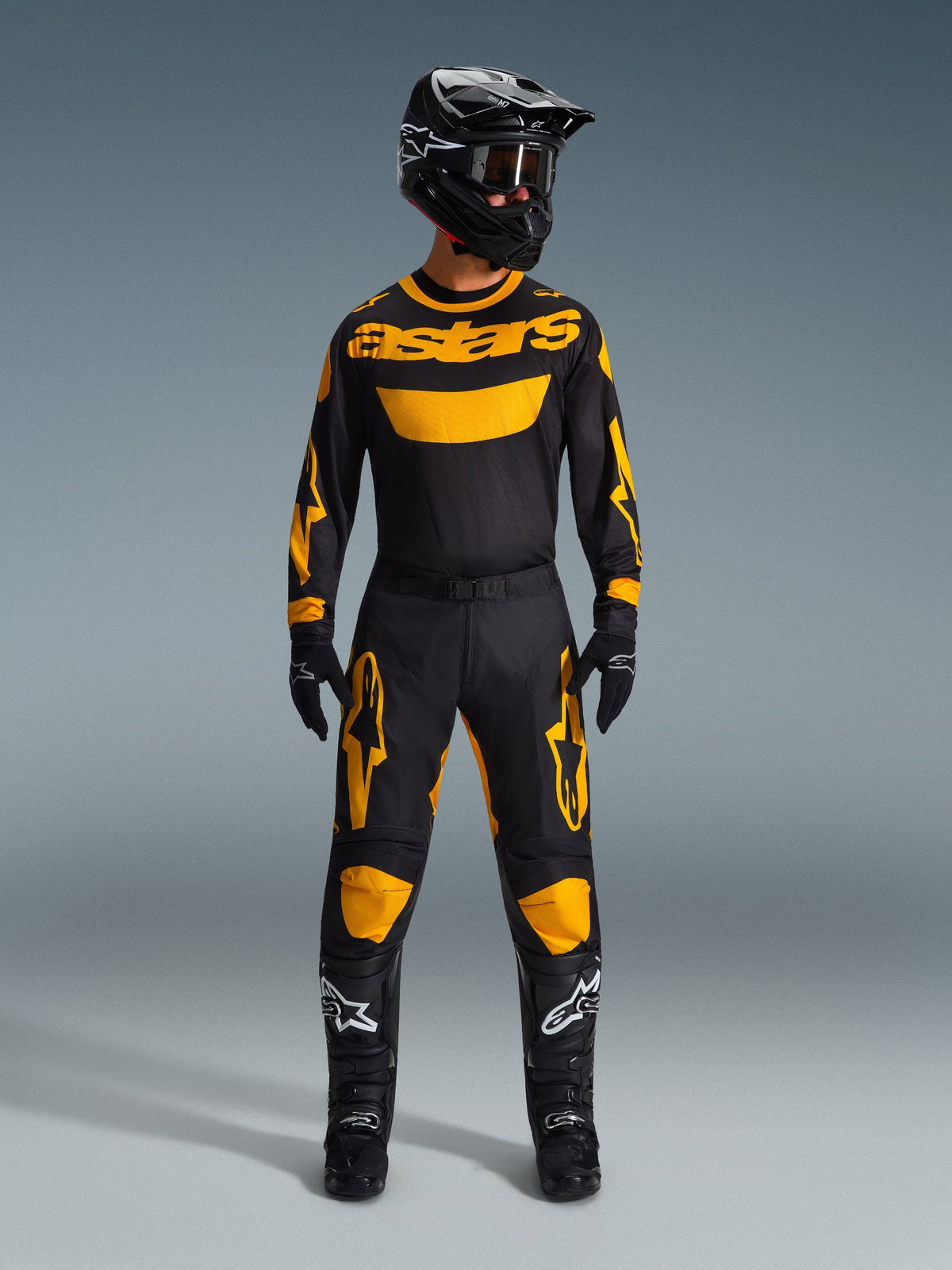 Alpinestars 2026 Racer Riway Pants, Motocross Pants, Yellow and Black, worn as a complete racing kit with matching long-sleeve jersey, black helmet, black goggles, and black boots with white star logos, professional off-road riding gear