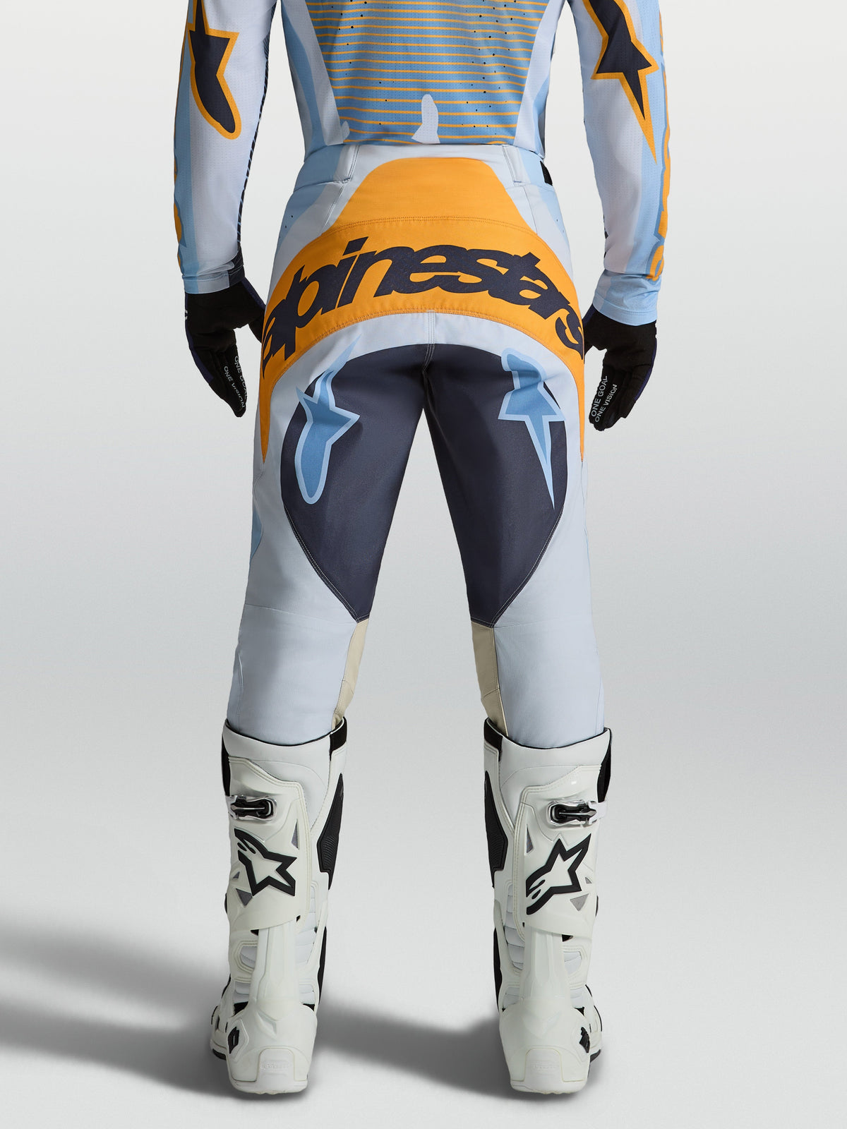 Alpinestars 2027 Techstar Maven Motocross Pants, Dust Blue and Tangerine, Men's on-model rear view with bold branding.