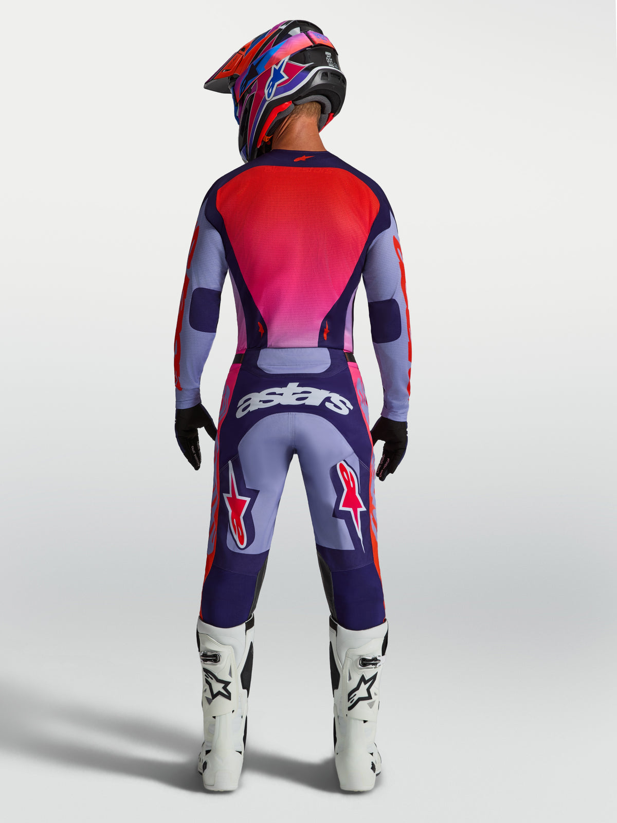 Alpinestars Racer Air Hunt Pants, Purple and Pink Motocross Gear on model from back, ventilated racing pants with astars logo.