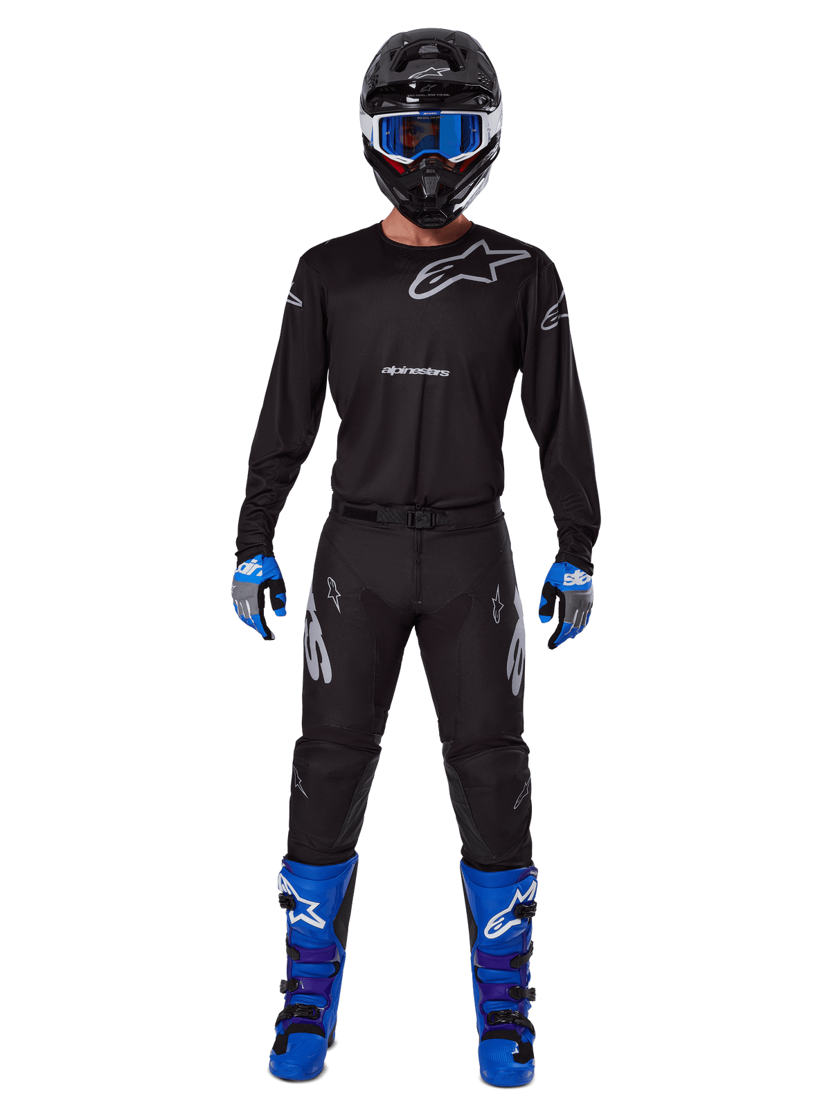 Alpinestars 2025 Racer Graphite Pants, Motocross Pants, Black and Gray, worn on a model with a matching black jersey, blue and purple boots, and blue goggles, complete off-road racing outfit featuring bold Alpinestars branding