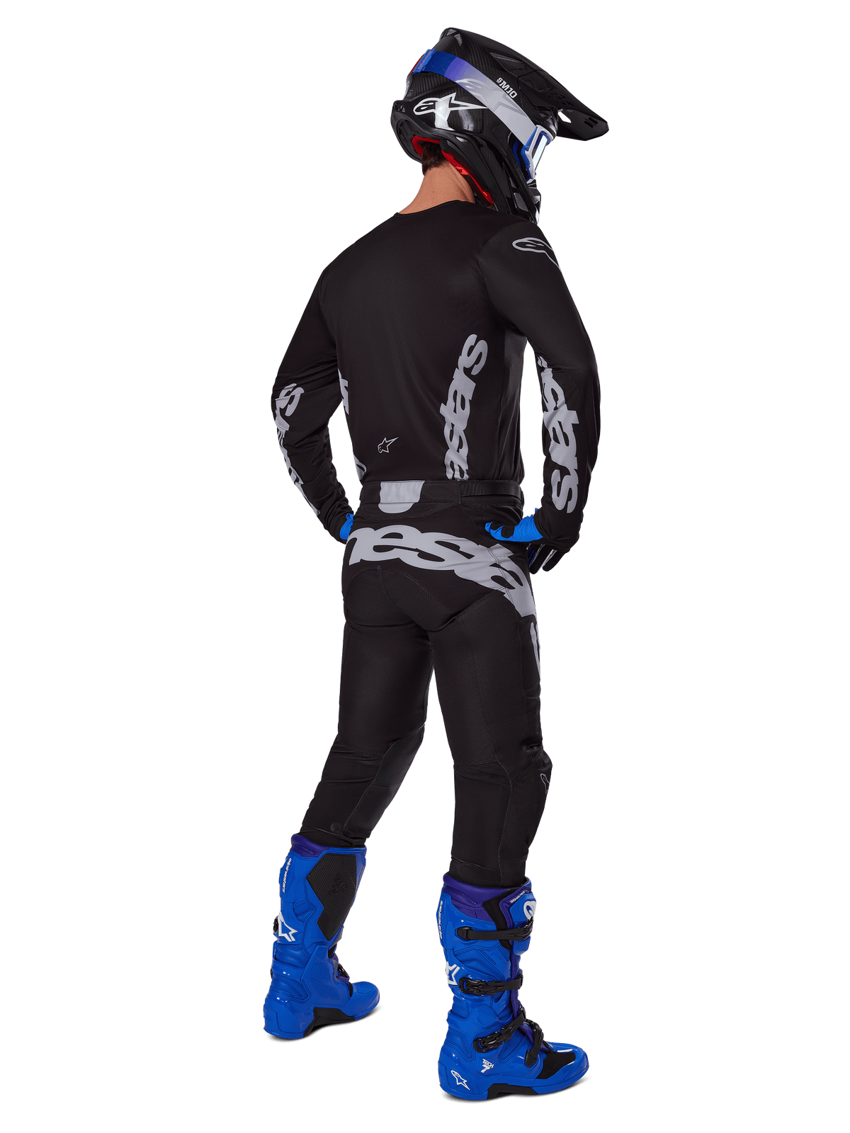 Alpinestars 2025 Racer Graphite Pants, Motocross Pants, Black and Gray, back view of a rider in a full gear set with a matching jersey and bright blue boots, featuring large gray branding on the seat and an ergonomic pre-curved design for off-road racing.