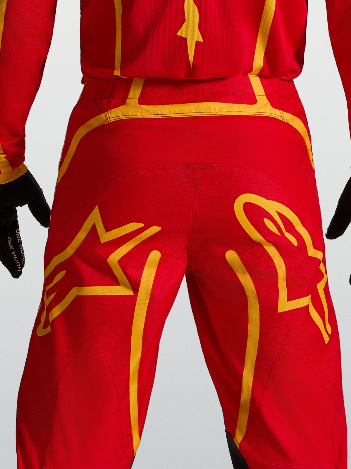 Alpinestars Fluid Apex V2 Pants, Motocross performance gear, Red and Gold, featuring reinforced back yoke and star graphics.