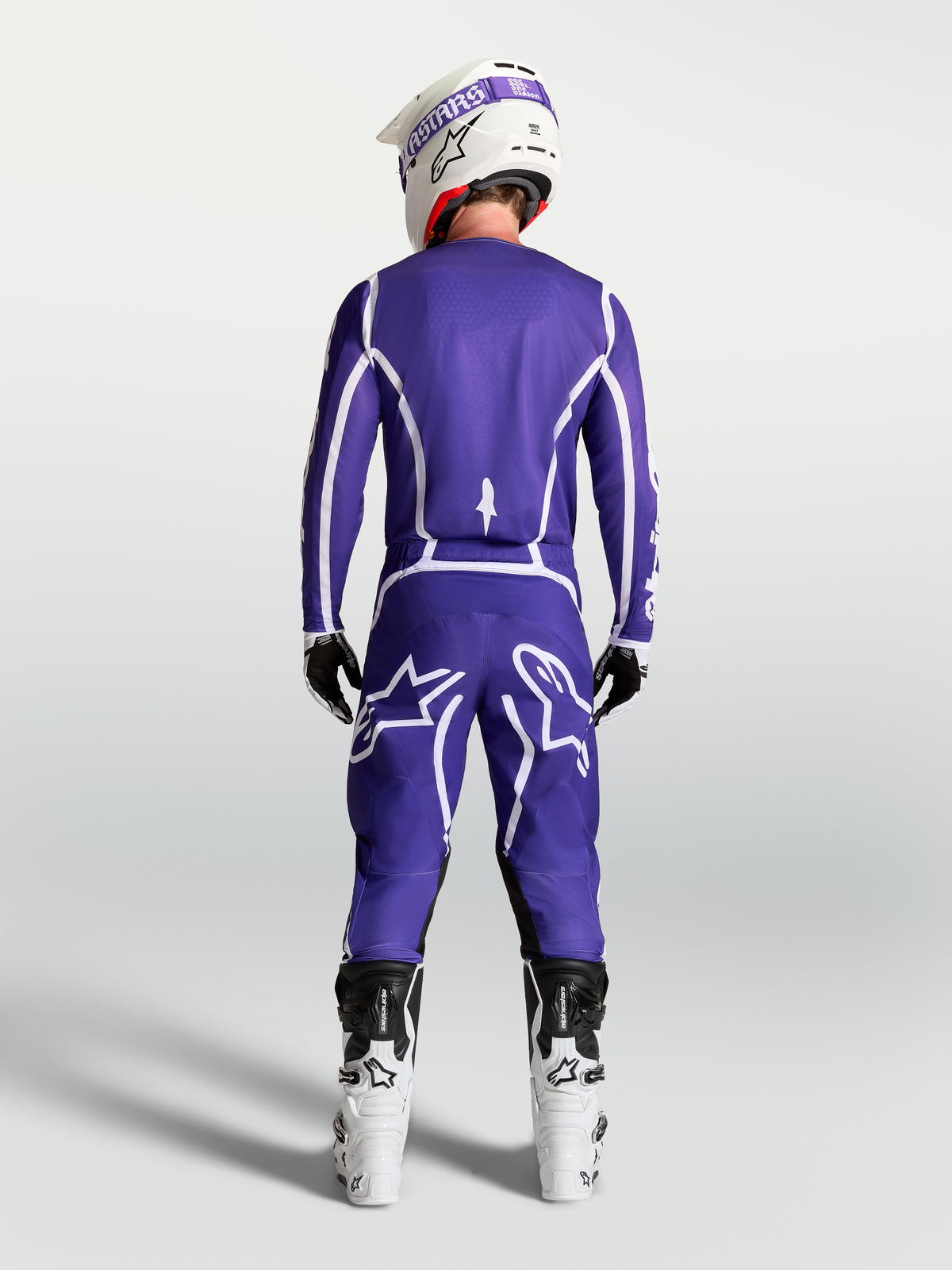 Alpinestars pantalones Fluid Apex V2 azules y blancos, equipo de motocross para hombre, vista trasera con botas de carreras
