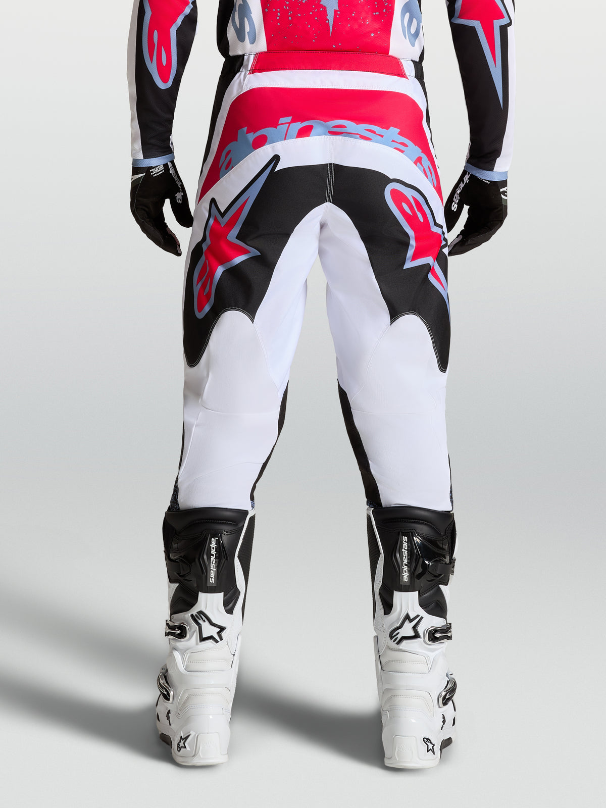 Alpinestars Fluid Drag Pants, Motocross Racing Pants for Men, White and Black, Durable 600D Polyfabric with Red Accents.