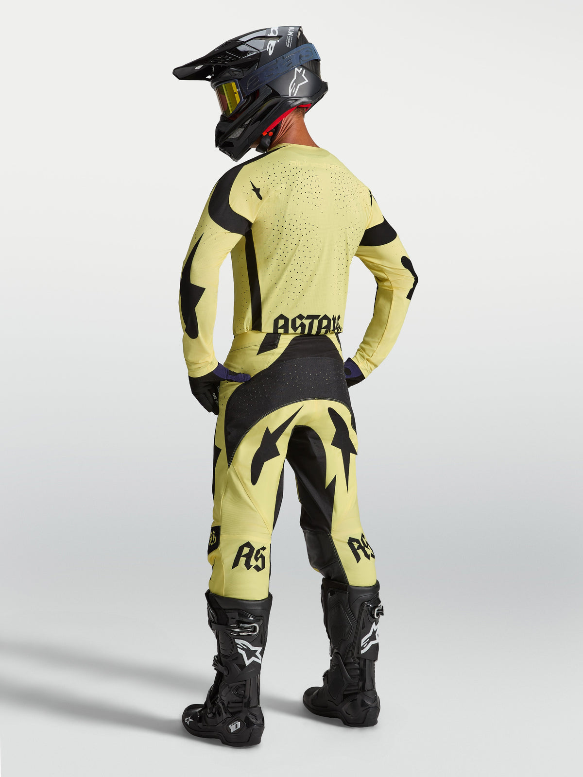 Alpinestars Techstar Atrox Pants and Gear Set, yellow and black motocross outfit, rear view on model with racing boots.
