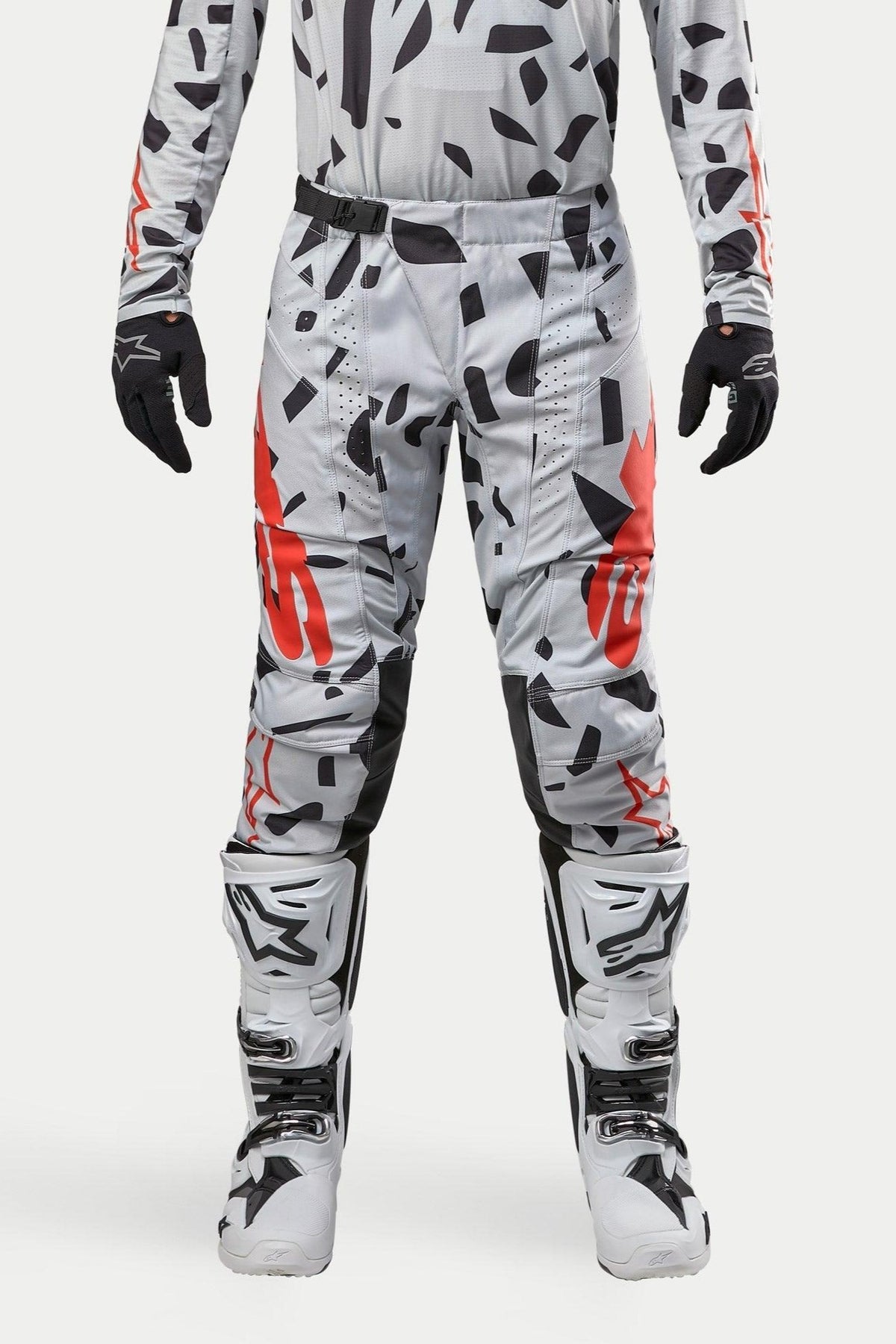 Alpinestars 2024 Techstar Rantera Pants, Motocross Pants, Haze Gray Camo, worn with matching jersey, black gloves and white boots, featuring black spot pattern and red Alpinestars branding, durable design for off-road racing