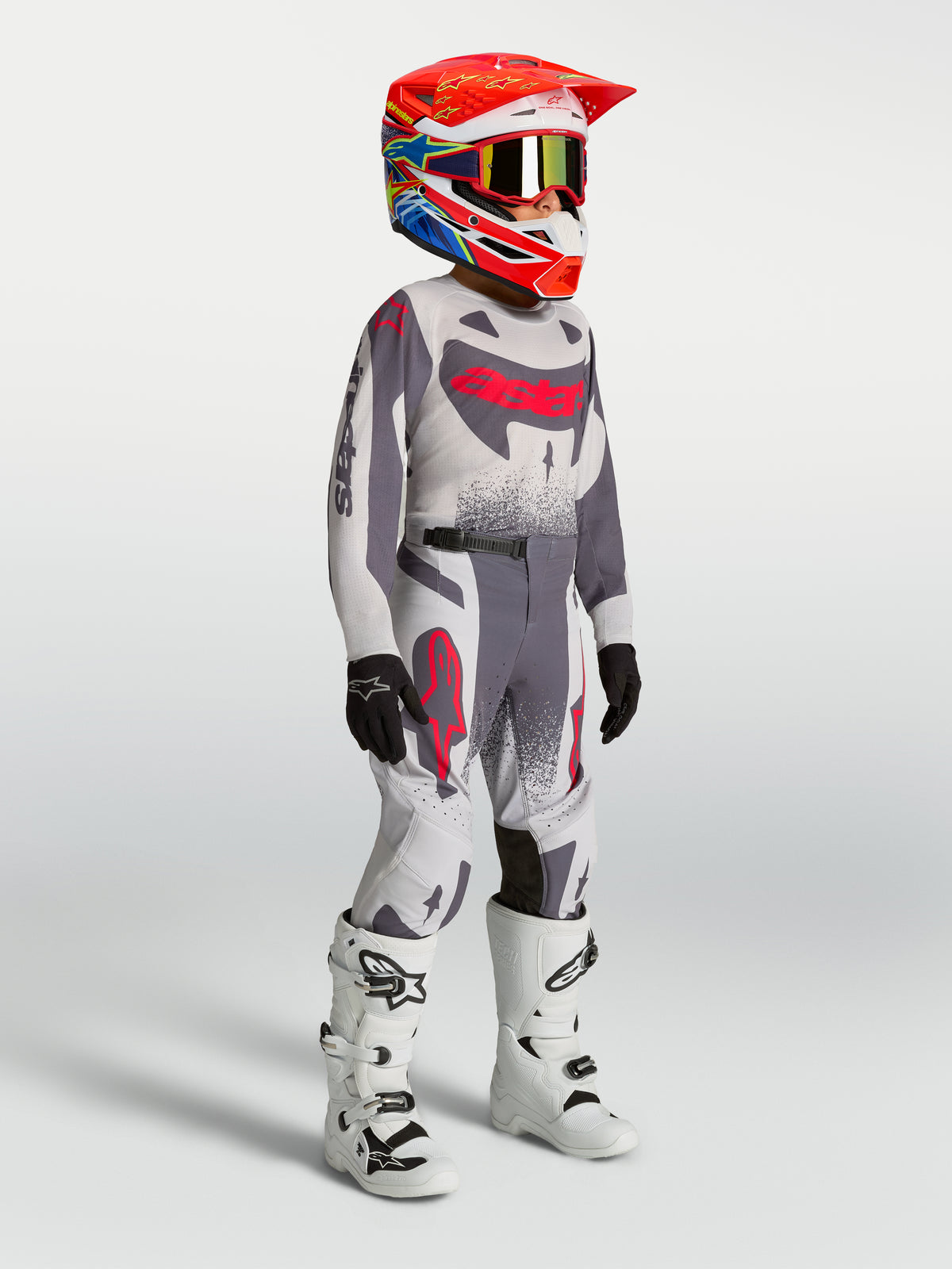 Pantalones Alpinestars Supertech Swan Juveniles, equipo de motocross para niños, gris y rojo fluo, diseño elástico duradero.