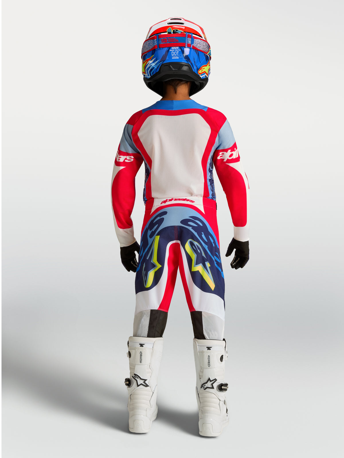 Alpinestars pantalones Supertech Dyna juvenil, equipo de motocross rojo y azul marino en vista trasera.