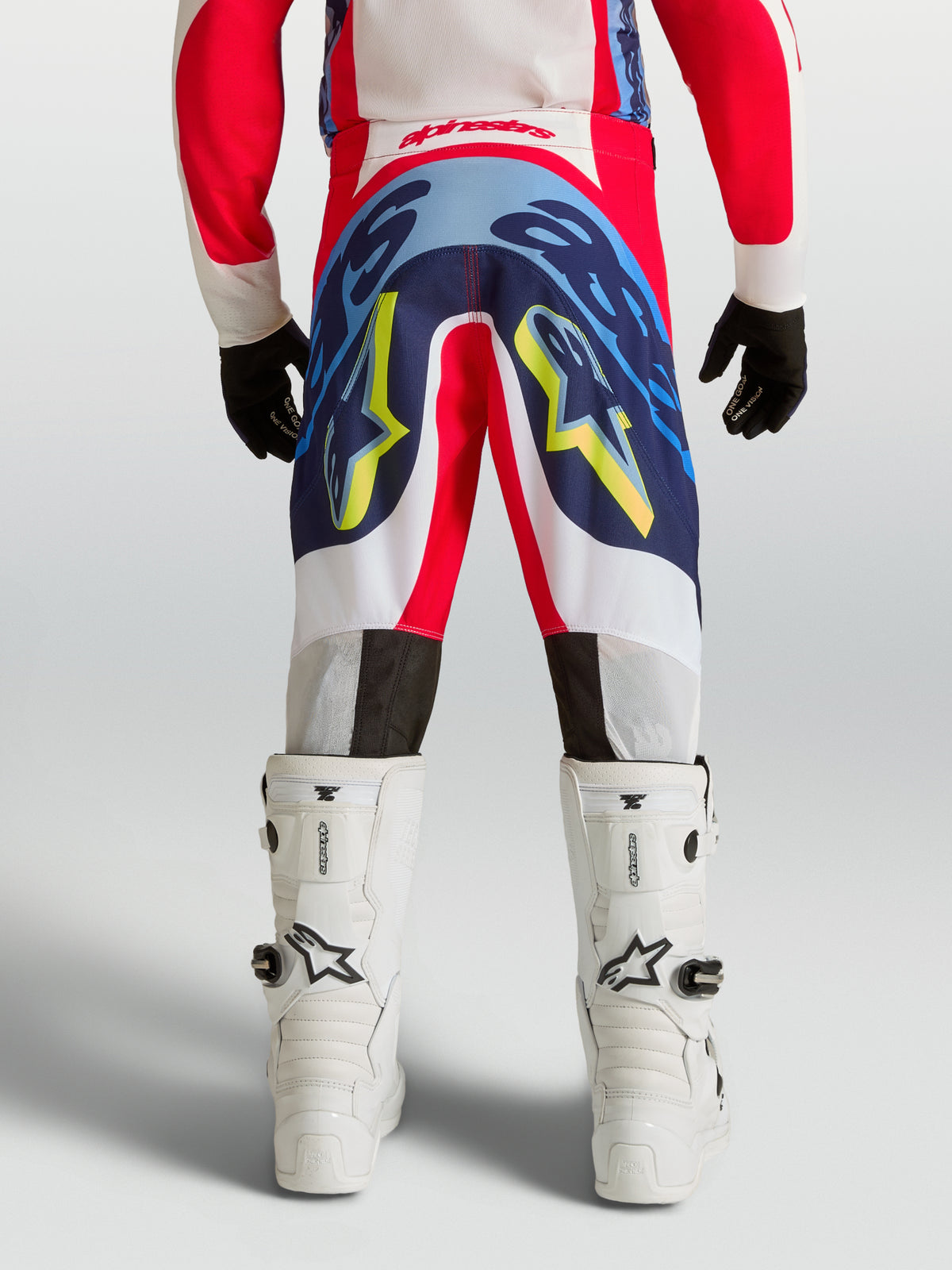 Pantalones Alpinestars Supertech Dyna Juvenil, equipo de motocross en rojo y azul marino con diseño elástico duradero.