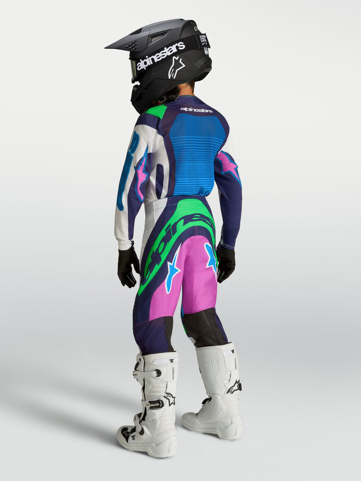 Pantalones Alpinestars Supertech Maven Juvenil, equipo de motocross en azul, rosa y verde, ajuste de rendimiento para jóvenes pilotos de carreras.