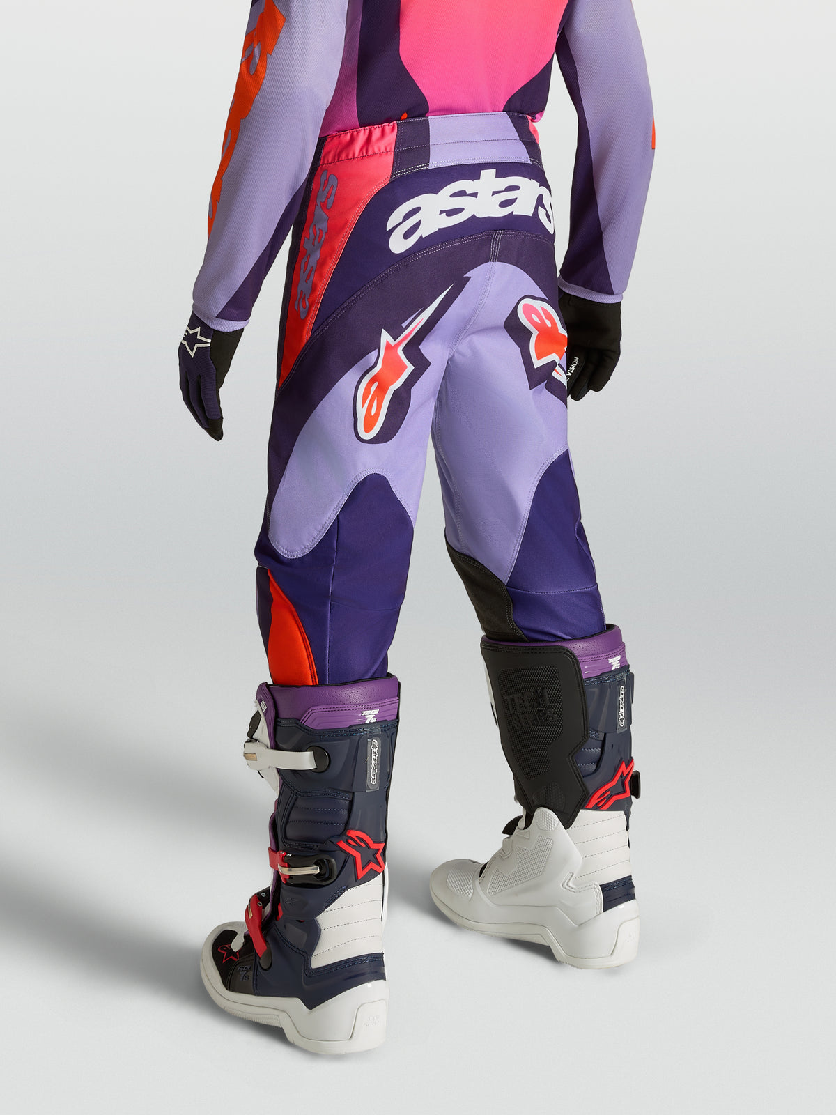 Alpinestars Youth Fluid Hunt Pants, purple and pink motocross gear with durable 600D polyfabric, rear view on-model.
