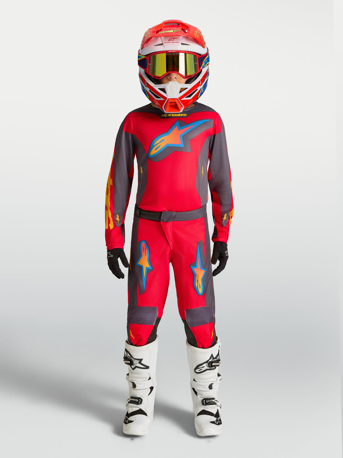 Pantalones Alpinestars Fluid Hunt Juvenil de motocross, rojos y grises, ajuste deportivo para rendimiento todoterreno.