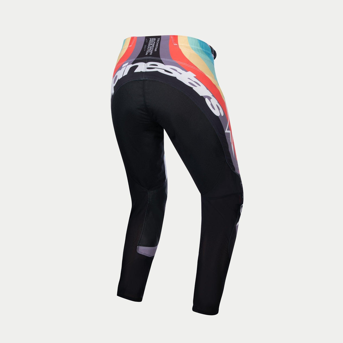 Alpinestars Stella Techstar Pants 2024 para mujer, pantalones de motocross, Negro Multicolor, vista trasera con un vibrante patrón de ondas en rojo, naranja y azul en la cintura, gran marca Alpinestars en blanco en la parte trasera, diseñados para carreras todoterreno