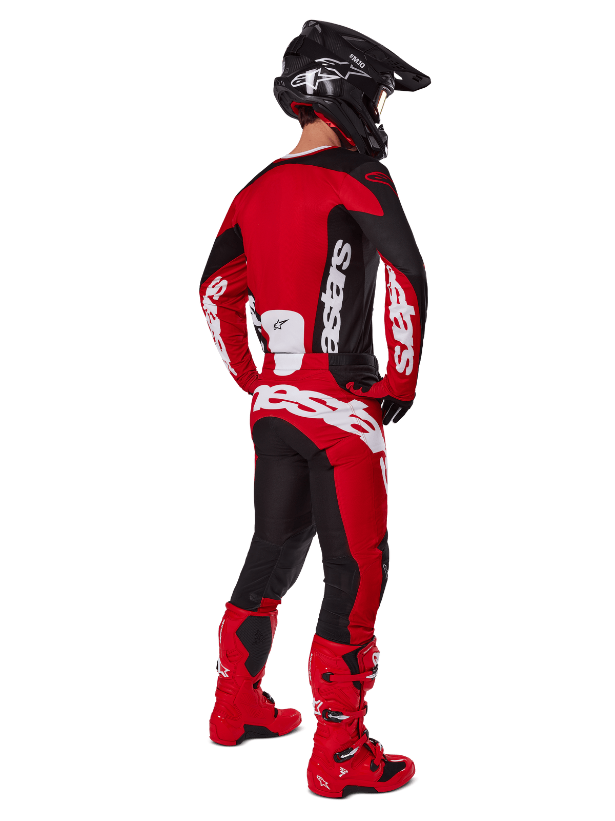 Motocross rider from the back wearing the Alpinestars 2025 Racer Veil Jersey in Black and Bright Red, coordinated with matching red and black pants and red motocross boots, featuring large white branding, ideal for off-road performance