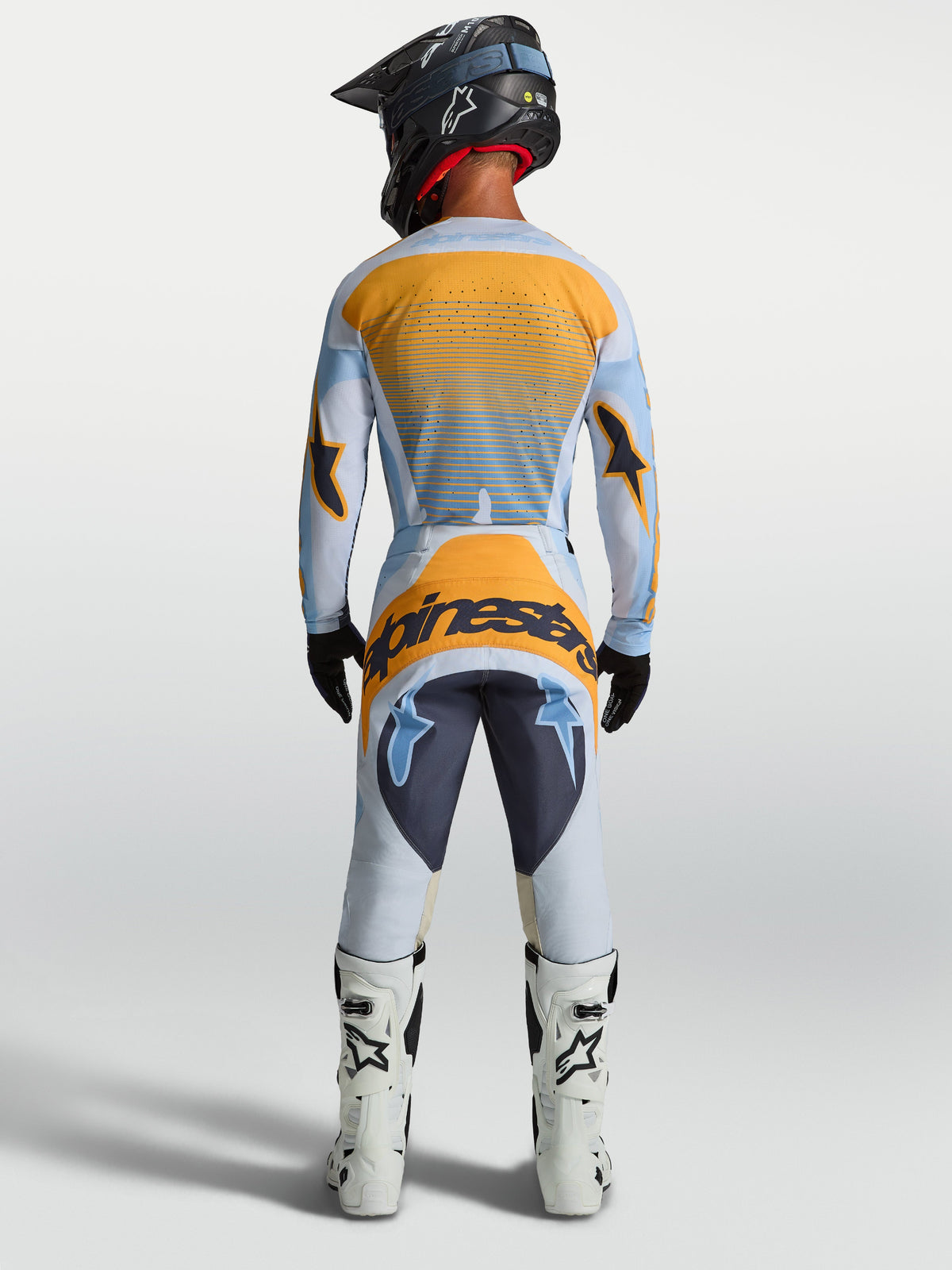Jersey y conjunto Alpinestars Techstar Maven para motocross de hombre, azul y naranja, vista trasera.