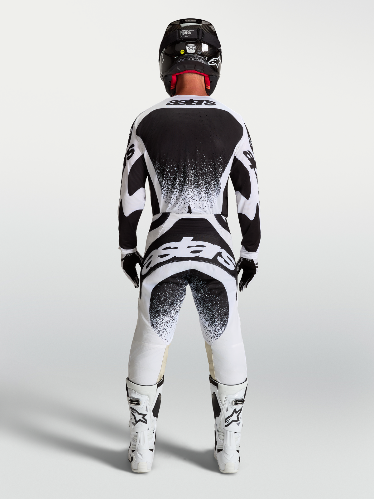 Jersey y conjunto Techstar Swan de Alpinestars para motocross, blanco y negro con gráficos traseros de efecto salpicadura.