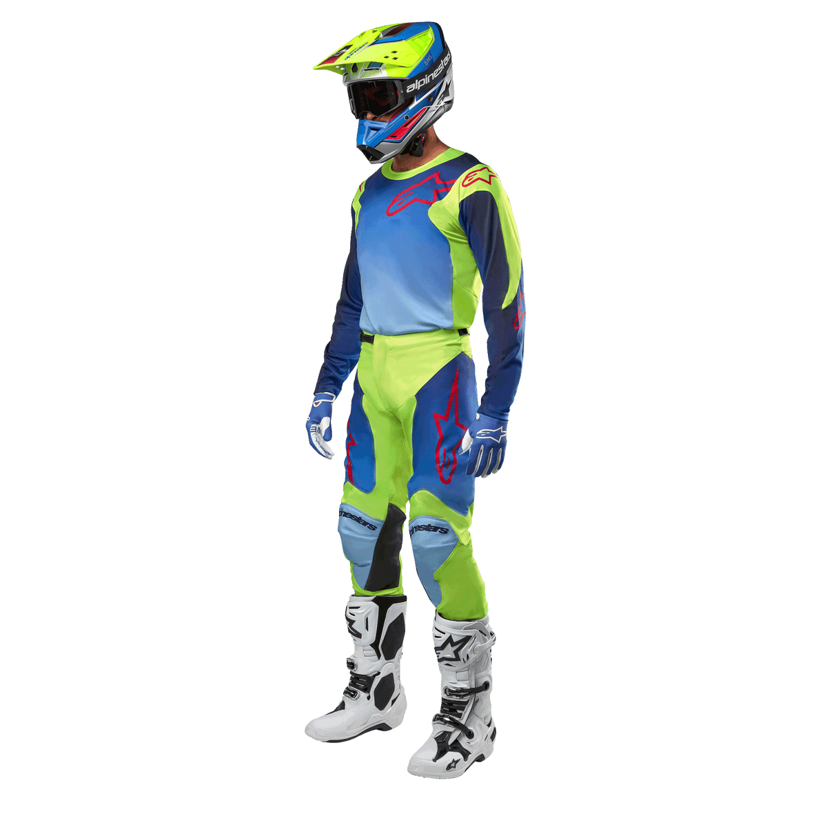Alpinestars 2024 Racer Hoen Jersey, jersey de motocross, amarillo flúor y azul night navy, usado por un piloto con pantalones a juego, casco y botas blancas, equipamiento profesional para conducción fuera de carretera