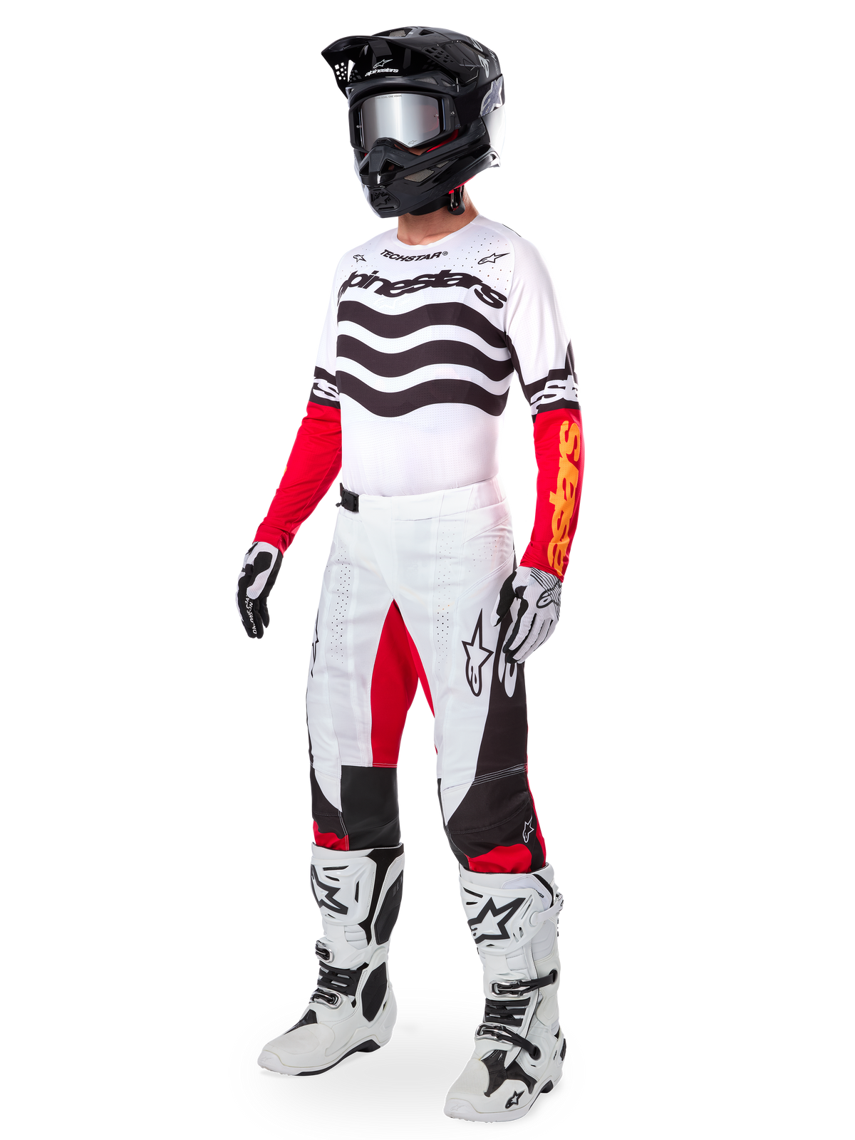 Motocross rider wearing complete racing gear, Limited Edition Techstar Deep Jersey with white and black wavy stripes and red sleeves, matching white and red pants, black helmet, white and black boots, coordinated outfit for off-road racing