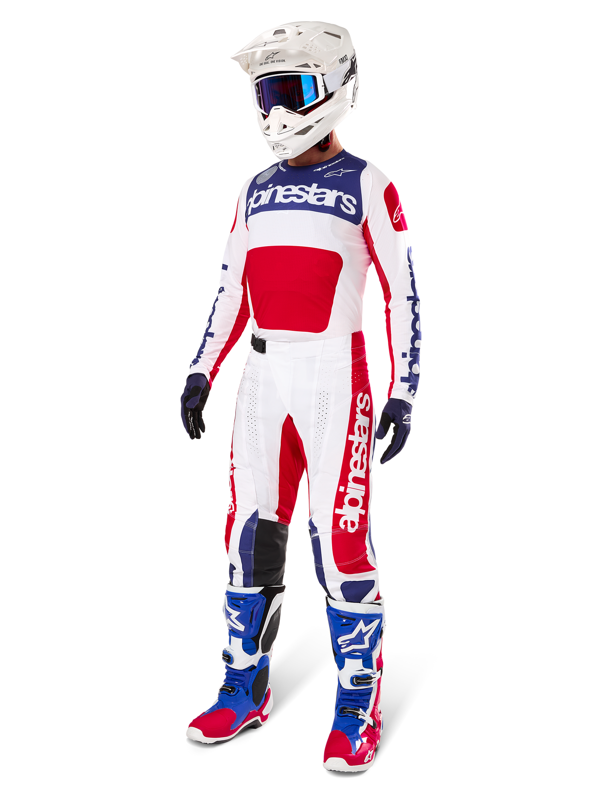 Motocross rider wearing complete racing gear, featuring the Alpinestars Limited Edition Techstar Fortitude Jersey in Bright Red, White, and Blue. Matching motocross pants, white helmet with blue goggles, and blue and red boots, providing a coordinated look for off-road competition.