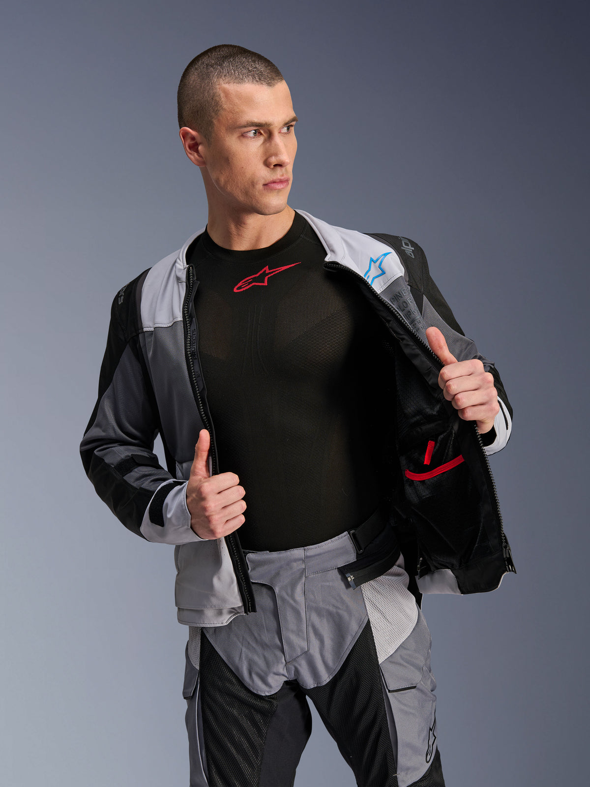 Alpinestars ST-2 Air Jacket, Ice Gray Dark Gray Black, motorcycle touring jacket, worn open to show interior mesh lining and pockets, paired with matching pants and black base layer