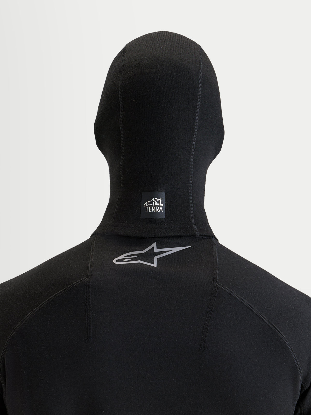 Alpinestars AT-8 Merino Balaclava, motorcycle adventure riding balaclava, black, rear view showing flatlock seams and All Terra branding logo
