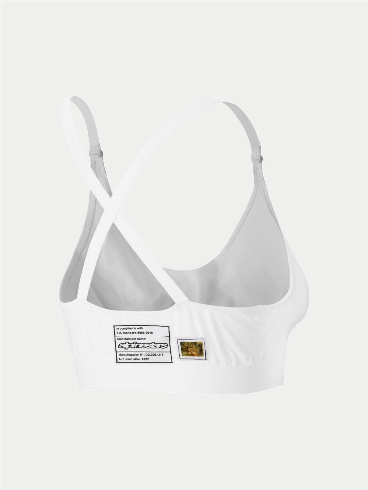 Alpinestars Stella TECH ZX Bra, ropa interior de competición blanca resistente al fuego, vista trasera que muestra el diseño de tirantes cruzados, incluye etiqueta de homologación FIA 8856-2018 y holograma, capa base ligera de alto rendimiento para mujer