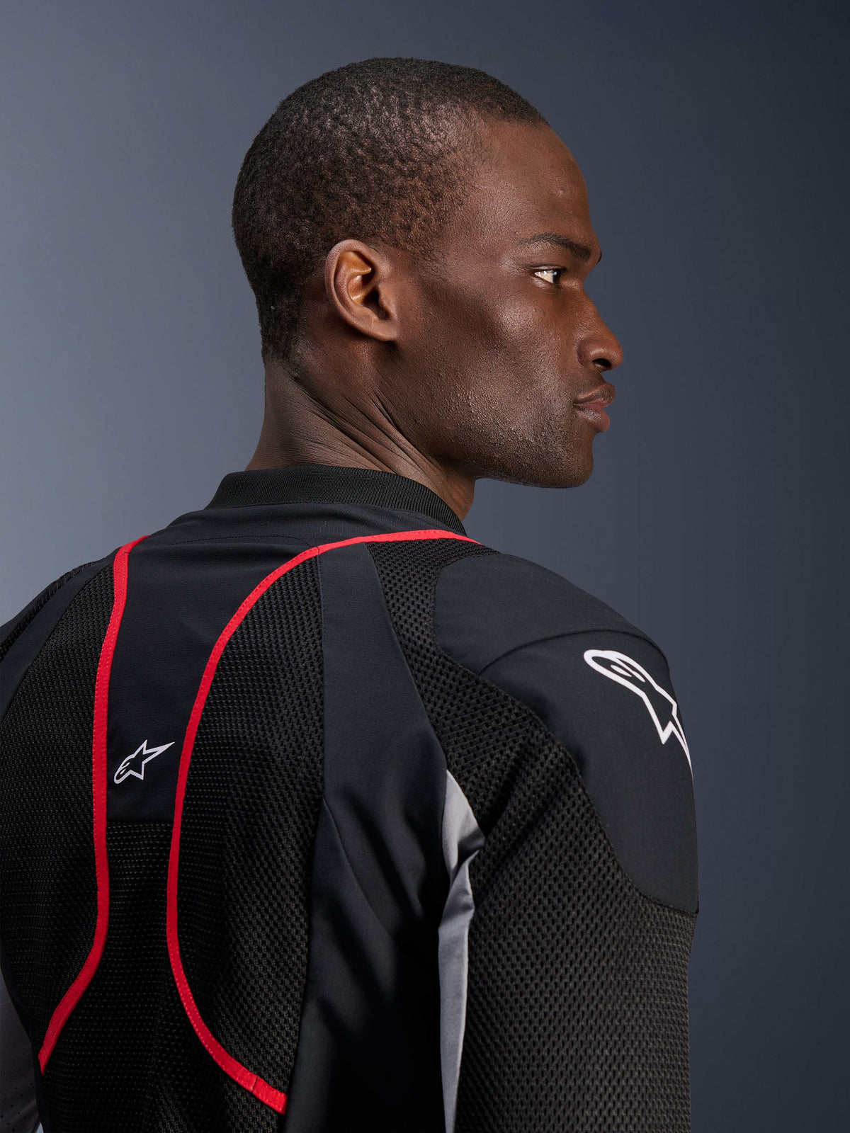 Alpinestars Troop-Air Pro Jacket, technical armored air jacket, Black Ash Gray and Bright Red, close-up profile and back view showing mesh textile panels, red piping accents, and white Astars logos on the shoulder and upper back