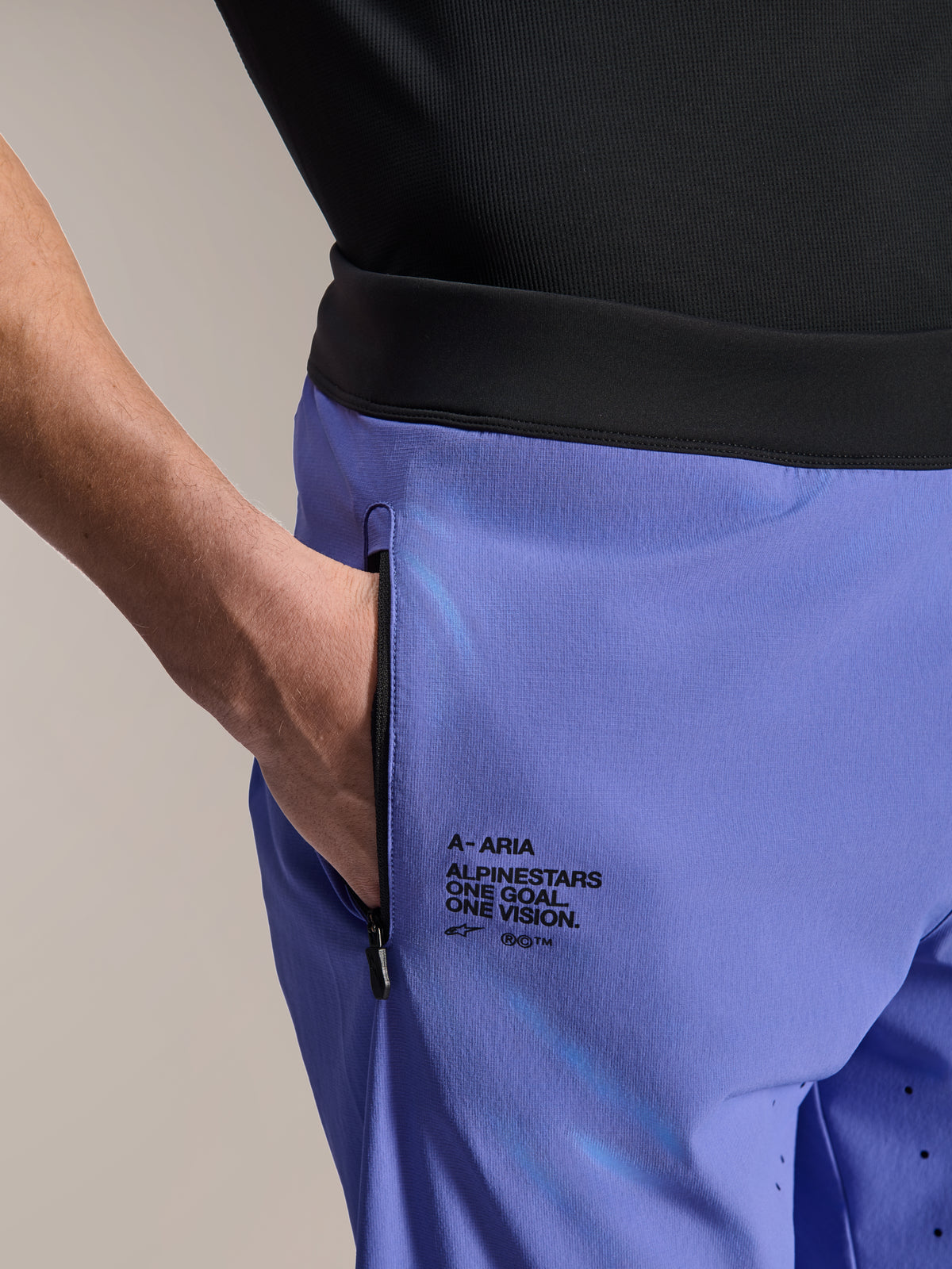 Alpinestars A-Aria Lite Short, MTB Shorts, Baja Blue, close-up showing zippered front pocket and side branding with "One Goal. One Vision." text, black waistband and technical fabric for mountain biking