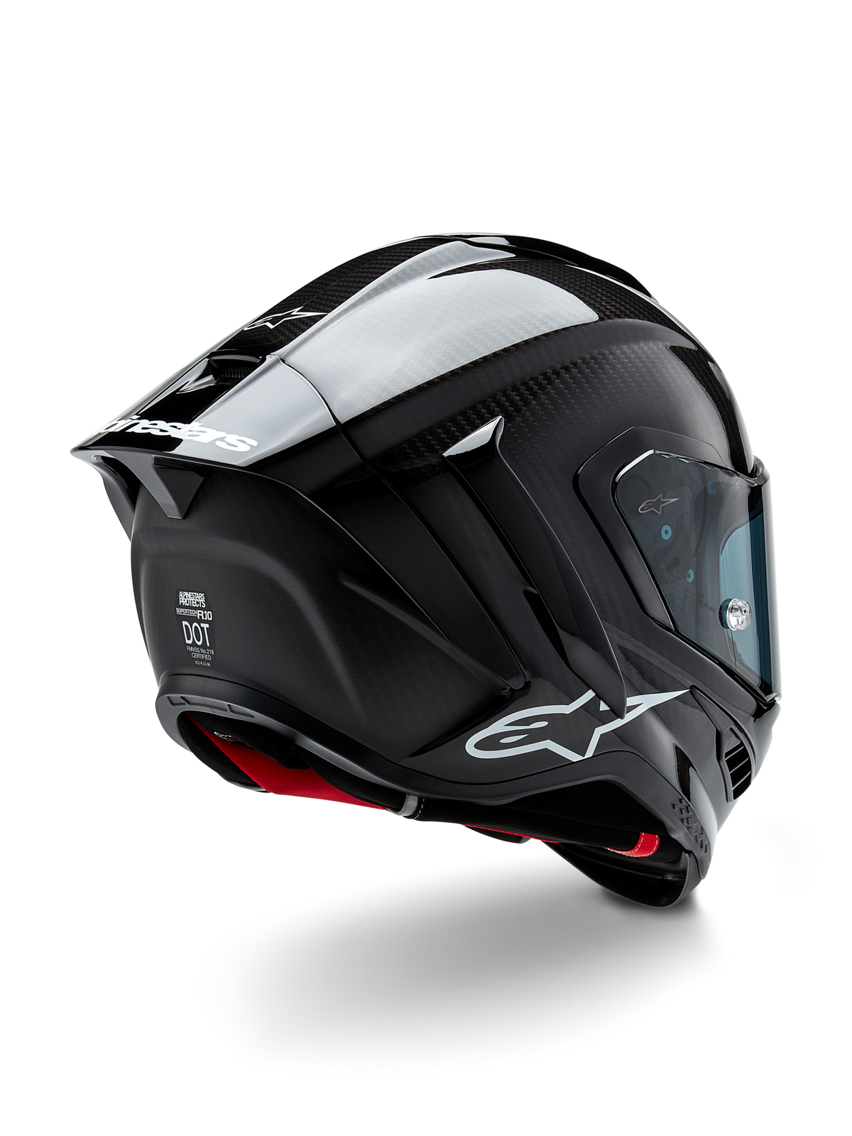 Casco Alpinestars Supertech R10 Solid, casco de competición para motocicleta, acabado en carbono negro mate y brillante, vista trasera en tres cuartos que muestra la calota de fibra de carbono, el alerón aerodinámico y el logotipo de Alpinestars.