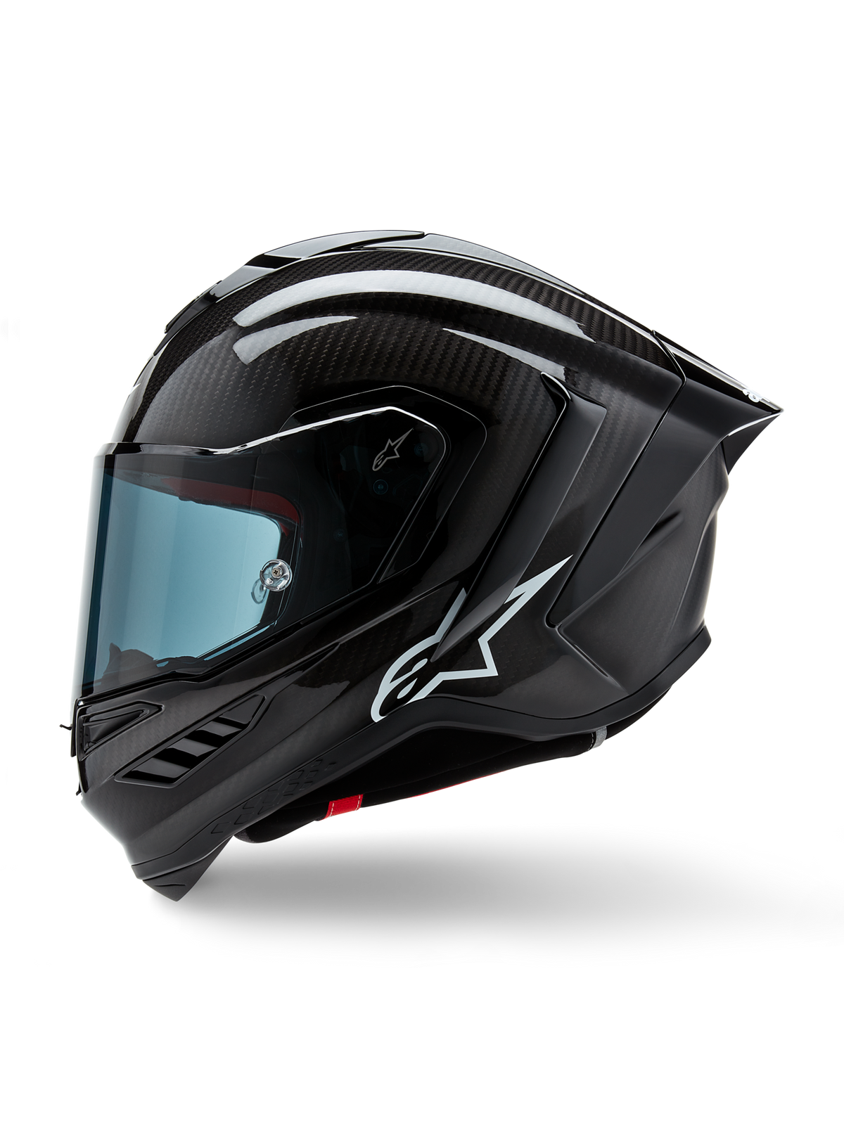 Casco Alpinestars Supertech R10 Solid, casco integral de carreras para moto, acabado en carbono negro mate y brillante, tejido de fibra de carbono visible, logotipo blanco de Alpinestars en el lateral, diseño aerodinámico con alerón trasero integrado y puertos de ventilación, vista de perfil lateral