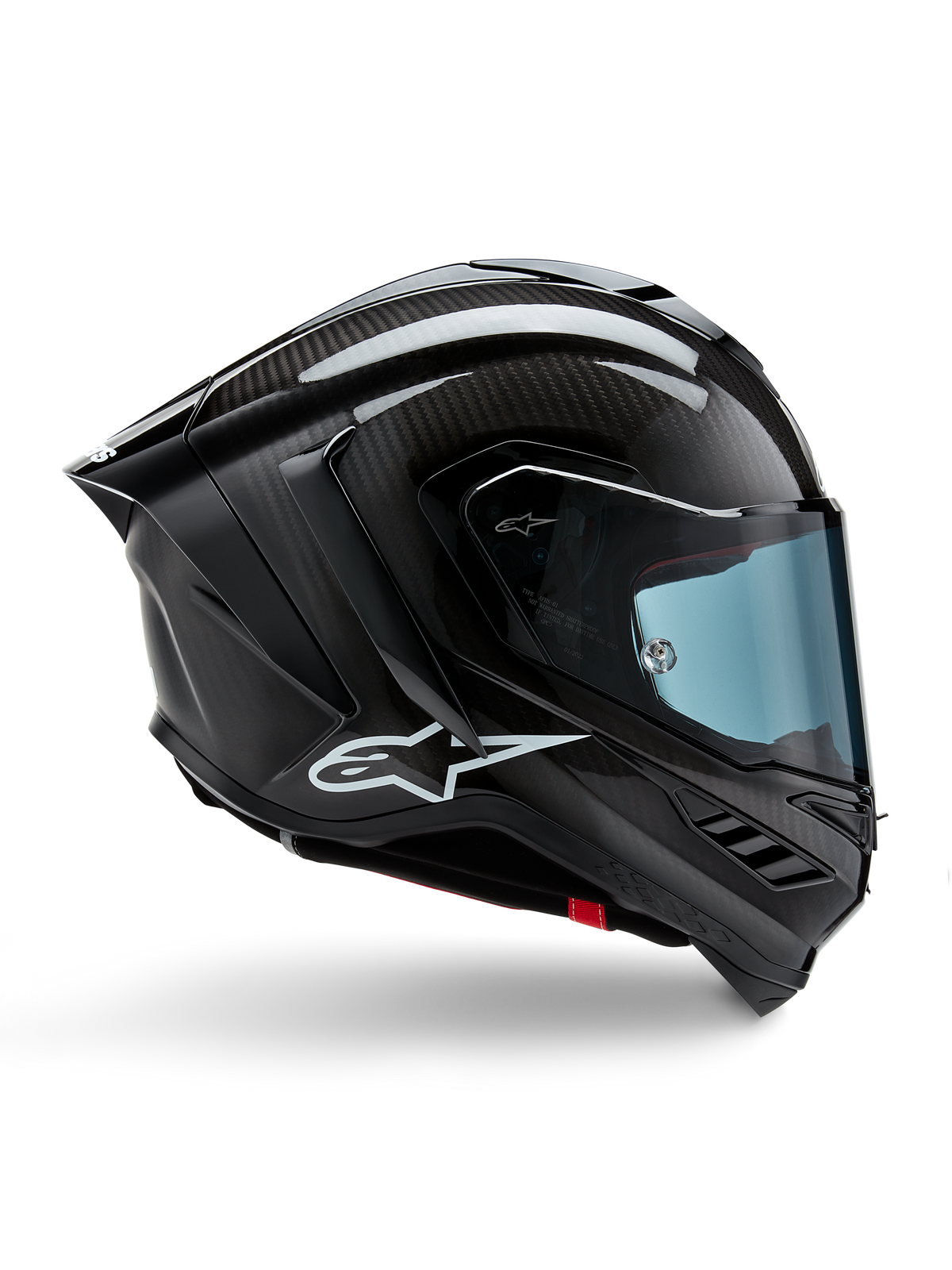 Casco Alpinestars Supertech R10 Solid, carbono negro mate y brillante, casco de competición para moto, construcción en fibra de carbono, perfil lateral, visera tintada en azul, diseño aerodinámico con alerones, logotipo blanco, protección de alto rendimiento de nivel MotoGP
