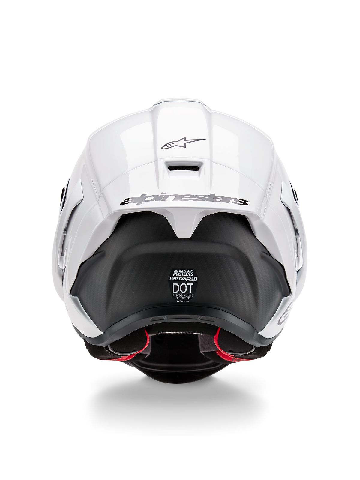 Casco Alpinestars Supertech R10 Solid, vista trasera, parte superior en blanco brillante con sección inferior en negro mate, alerón aerodinámico con el logotipo de Alpinestars en negro, textura de fibra de carbono visible y calcomanías de certificación de seguridad