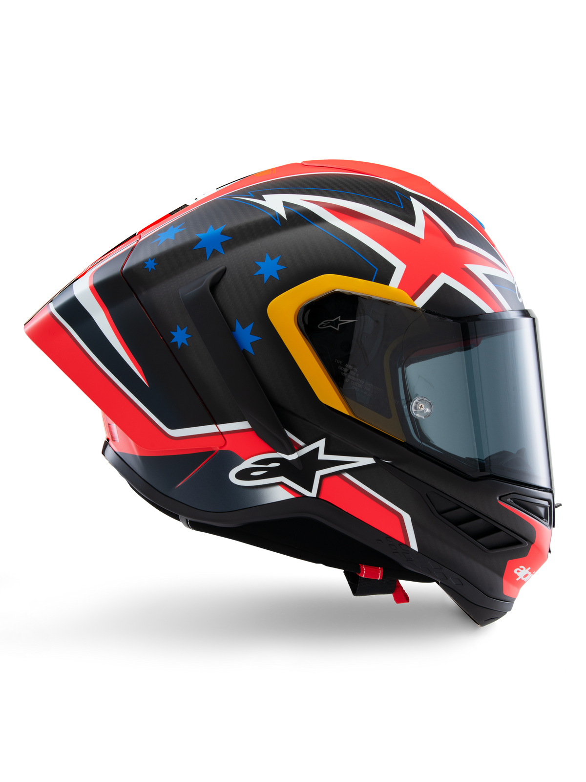Alpinestars Supertech R10 Miller Limited Edition Helmet, full-face racing helmet, matte carbon with red white and blue graphics, blue star accents and yellow visor trim, aerodynamic profile with dark smoke shield, high-performance motorcycle safety gear