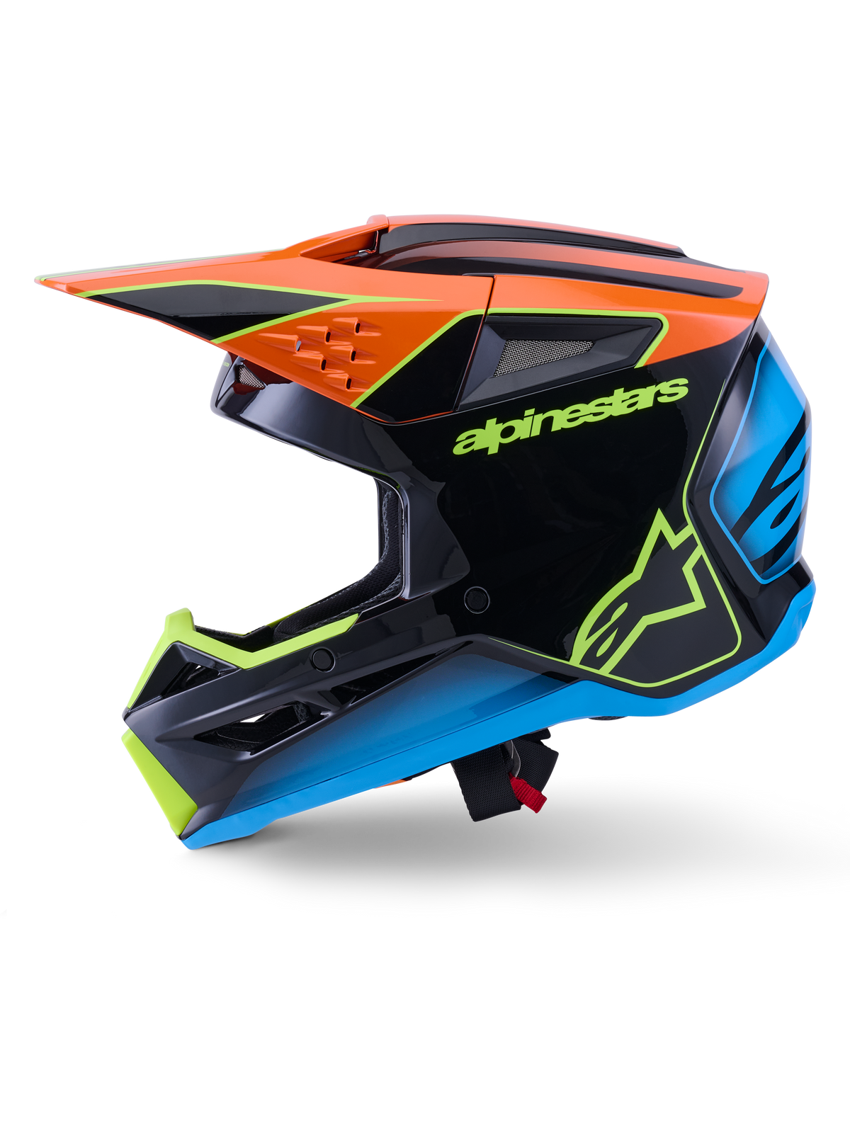Casco Alpinestars S-M3 Fray ECE 22.06, casco de motocross, negro con detalles en naranja, azul y amarillo fluorescente, vista de perfil lateral que muestra la calota aerodinámica y los puertos de ventilación integrados, con el logotipo de Alpinestars destacado, protección profesional para competiciones todoterreno