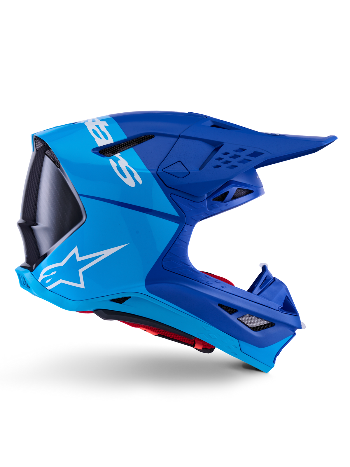 Casco Alpinestars Supertech M10 Flood, casco de motocross, azul metálico y azul medio con detalles de carbono negro, vista de perfil lateral, con logotipo blanco, diseño aerodinámico con puertos de ventilación, detalles con textura de fibra de carbono, protección profesional para carreras off-road