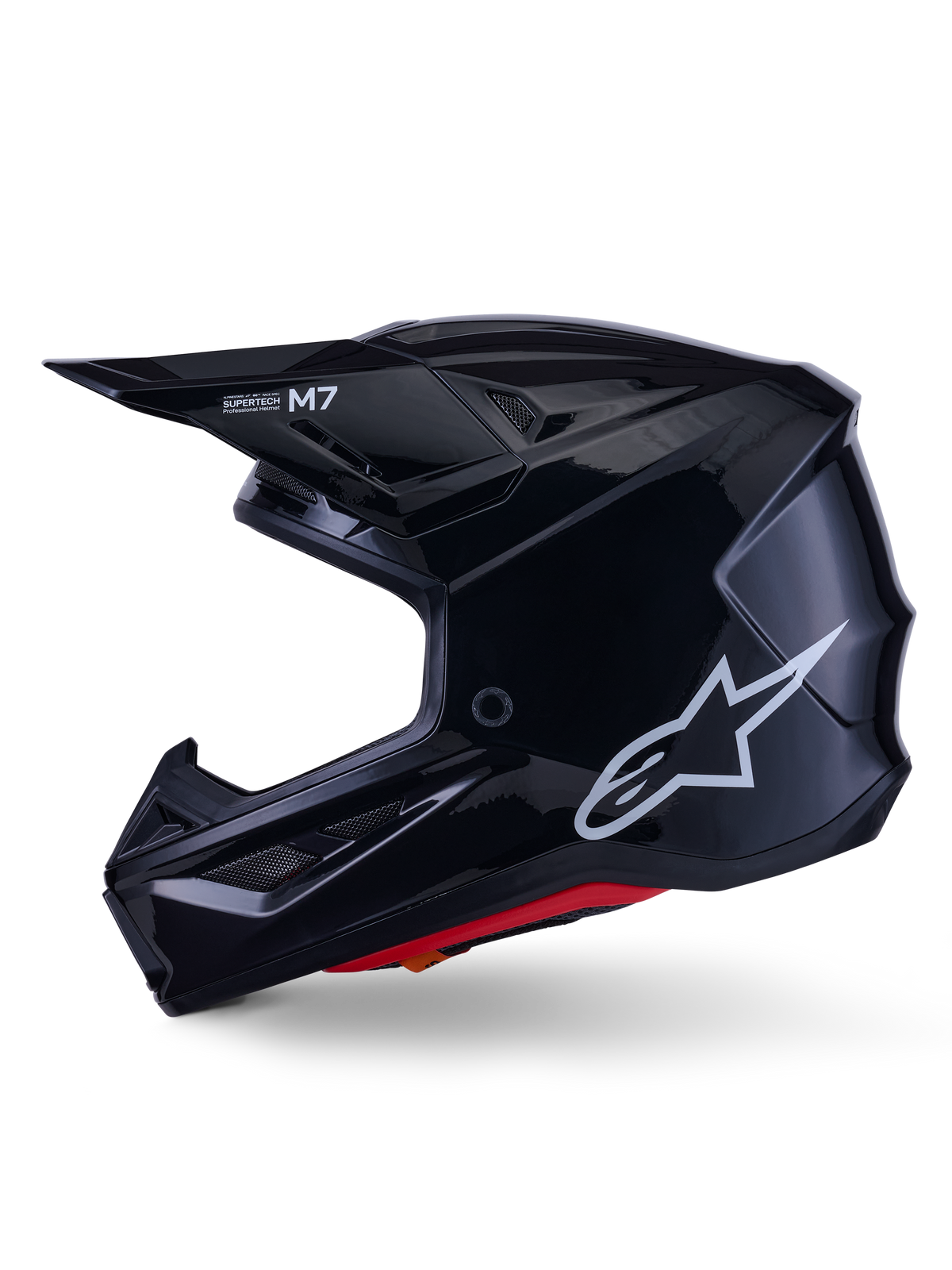 Casco Alpinestars S-M7 Solid, casco de motocross negro brillante, perfil lateral con logotipo blanco de Alpinestars, calota aerodinámica con rejilla de ventilación y acolchado interior rojo, protección avanzada para off-road