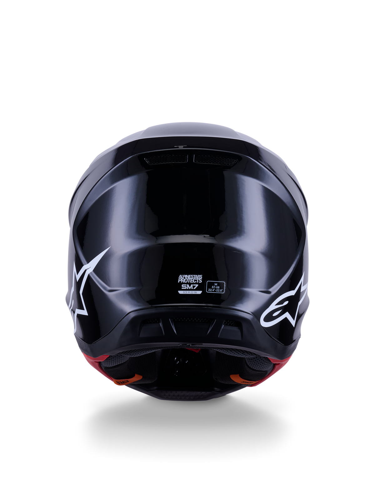 Alpinestars S-M7 Solid Helmet ECE 22.06, casco de motocross, negro brillante, vista trasera con logotipos de estrellas blancas, calota compuesta aerodinámica con acabado de alto brillo, etiquetas de certificación de seguridad y talla en el centro