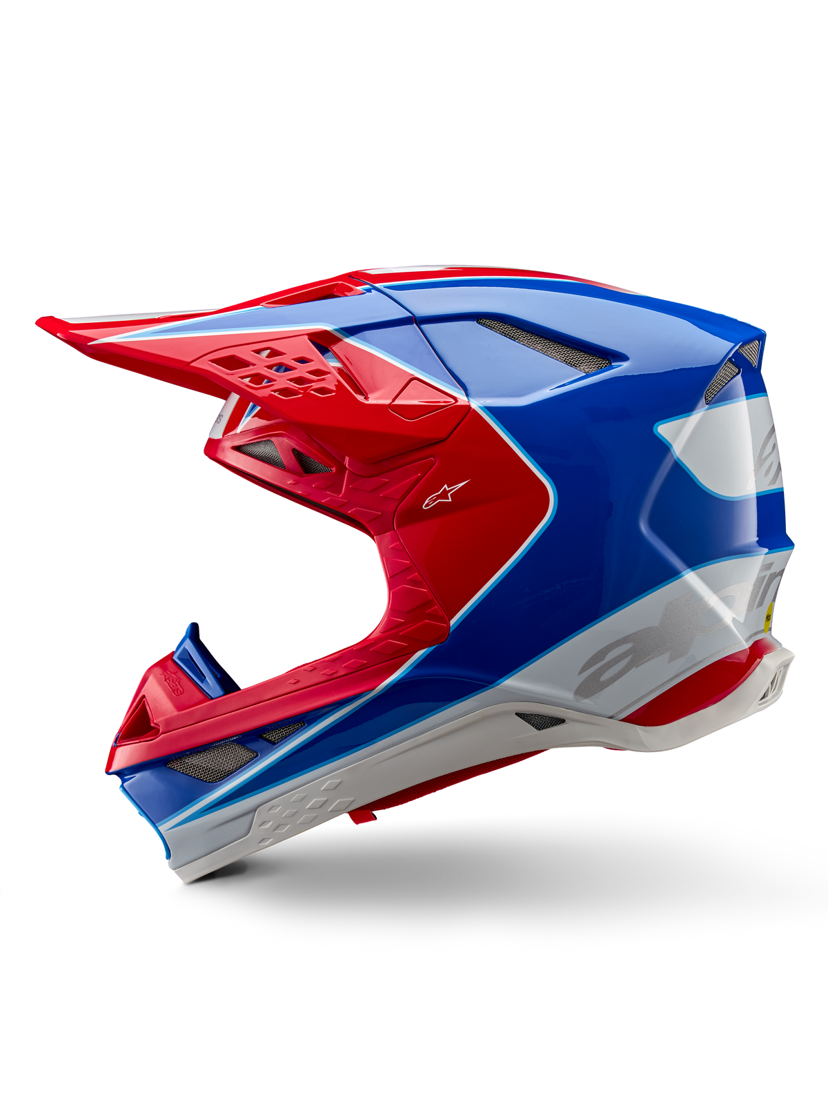Casco Alpinestars Supertech M10 Aeon ECE 22.06, casco de motocross, rojo y azul brillante, vista de perfil lateral, carcasa aerodinámica de compuesto múltiple con puertos de ventilación integrados y diseño gráfico en rojo y azul, acabado brillante para carreras todoterreno