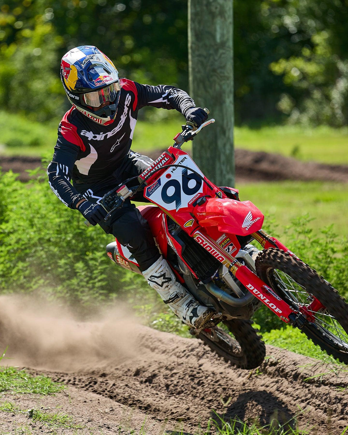Alpinestars 2025 Fluid Haul Gear Set, black and white motocross jersey and pants, worn by rider 96 on a red Honda bike.