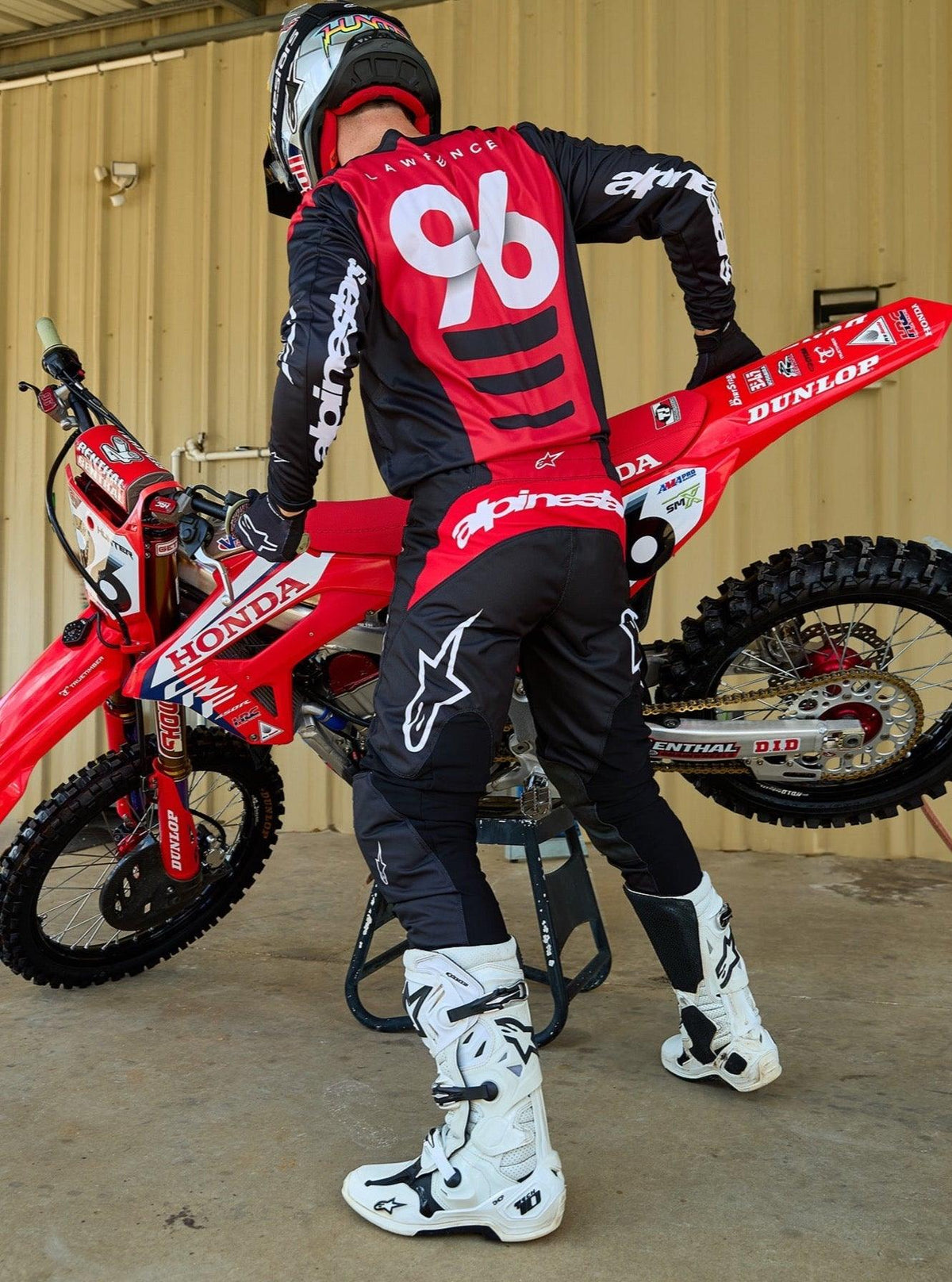 Alpinestars 2025 Fluid Haul Gear Set, motocross jersey and pants, black and red, worn by rider 96 with dirt bike.