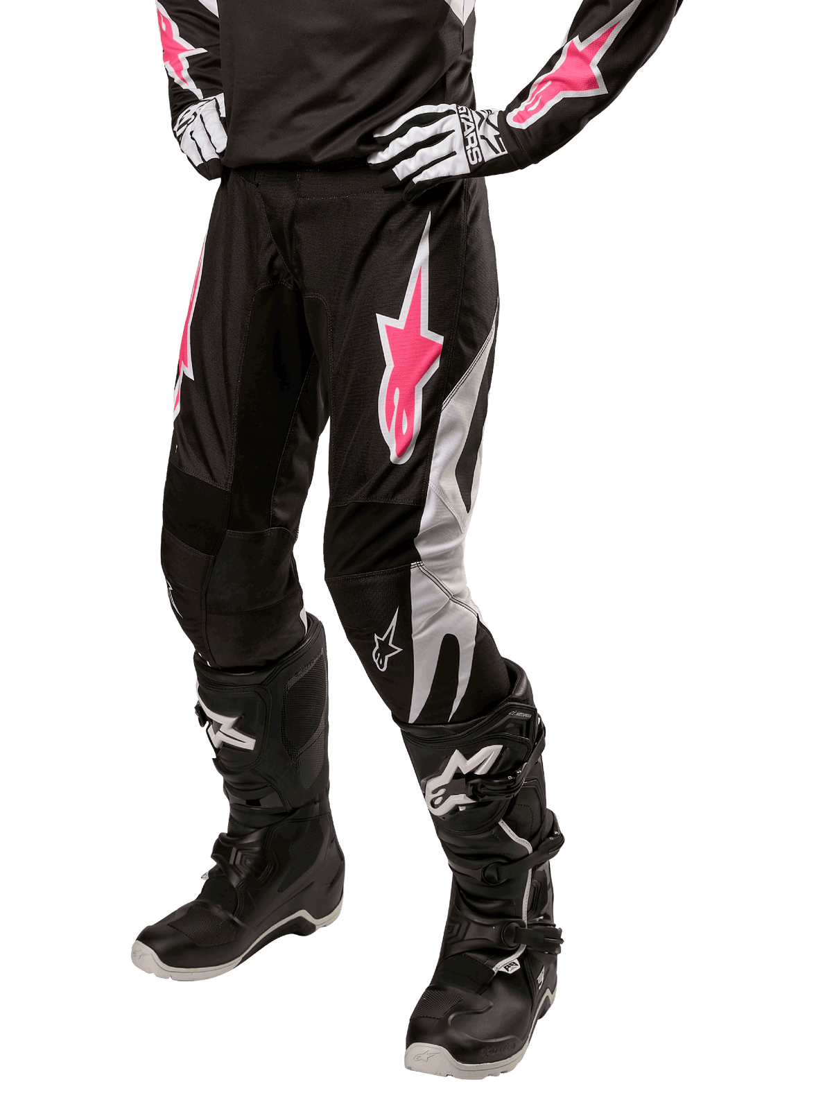 Alpinestars Stella Fluid Pant 2024 para mujer, pantalones de motocross negros y blancos con detalles en rosa, combinados con equipo de protección a juego, incluyendo botas y guantes, tejido duradero y flexible para conducción fuera de carretera