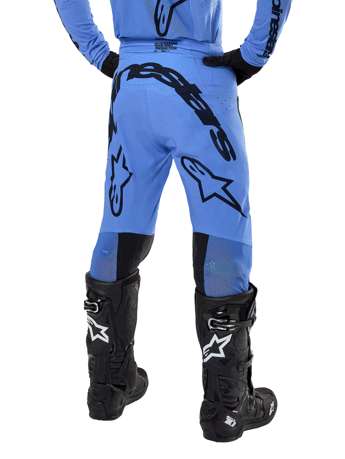 Alpinestars 2024 Supertech Dade Pants, Motocross Pants, Light Blue, rear view showing large black branding on the seat and legs, worn with black Alpinestars Tech 10 boots, athletic race fit for professional off-road performance.