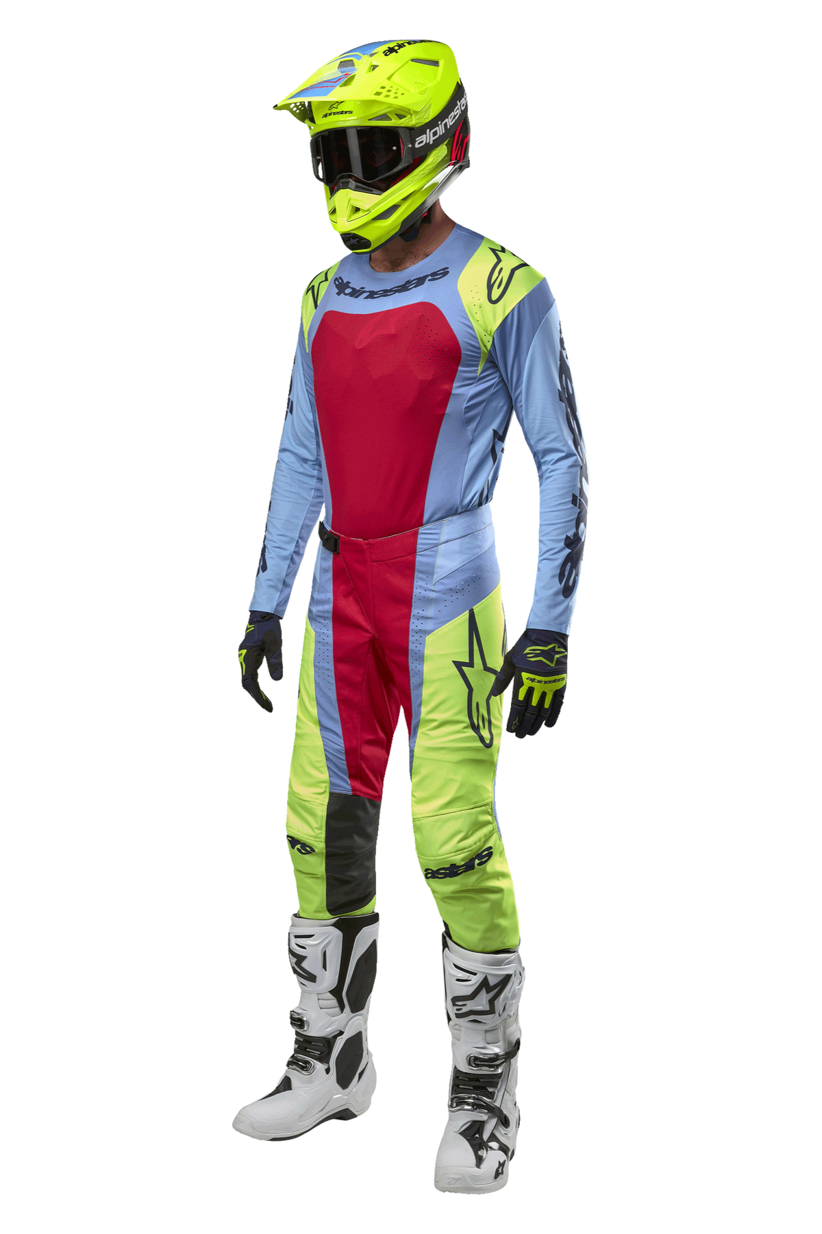Motocross rider wearing Alpinestars 2024 Techstar Ocuri Pants in Light Blue, Yellow Fluo, and Red Berry, coordinated racing gear including matching jersey, fluo yellow helmet, and white boots, front view of off-road competition outfit.