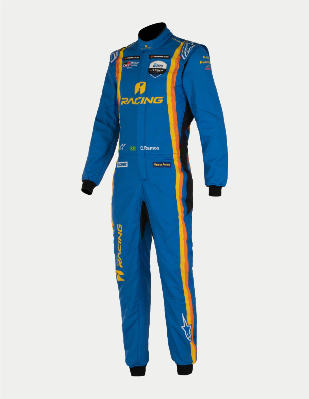Alpinestars Tech Vision V3, traje personalizado a medida para carreras, azul con franjas amarillas y naranjas, ignífugo y con certificación FIA.