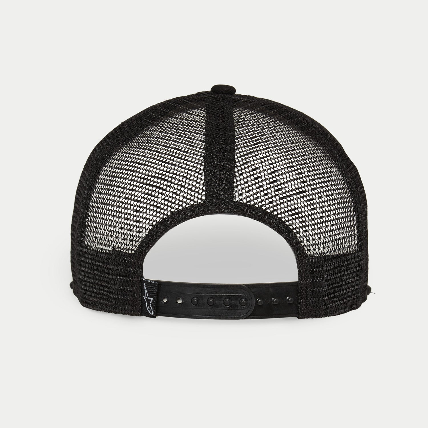 Gorra Alpinestars Corp Trucker, blanca y negra, vista trasera con paneles de malla transpirable negra, cierre snapback ajustable, pequeño logotipo de Alpinestars en la etiqueta trasera, accesorio casual inspirado en el automovilismo