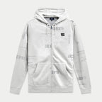 Sudadera con capucha Plenitude de Alpinestars, forro polar con cremallera frontal, color blanco roto con estampado integral de logotipos en gris, parche negro con el logotipo Ageless en el pecho, bolsillos tipo canguro y capucha con cordón, ropa urbana casual inspirada en el motorsport