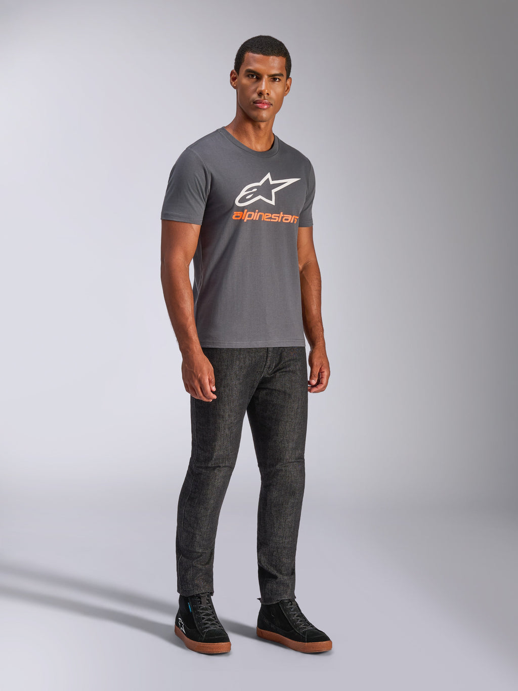 Alpinestars Always 2.0 CSF Tee, Short Sleeve T-Shirt, Charcoal Grey, White A-star Logo with Orange Branding, casual motorsport streetwear worn with dark jeans and black sneakers