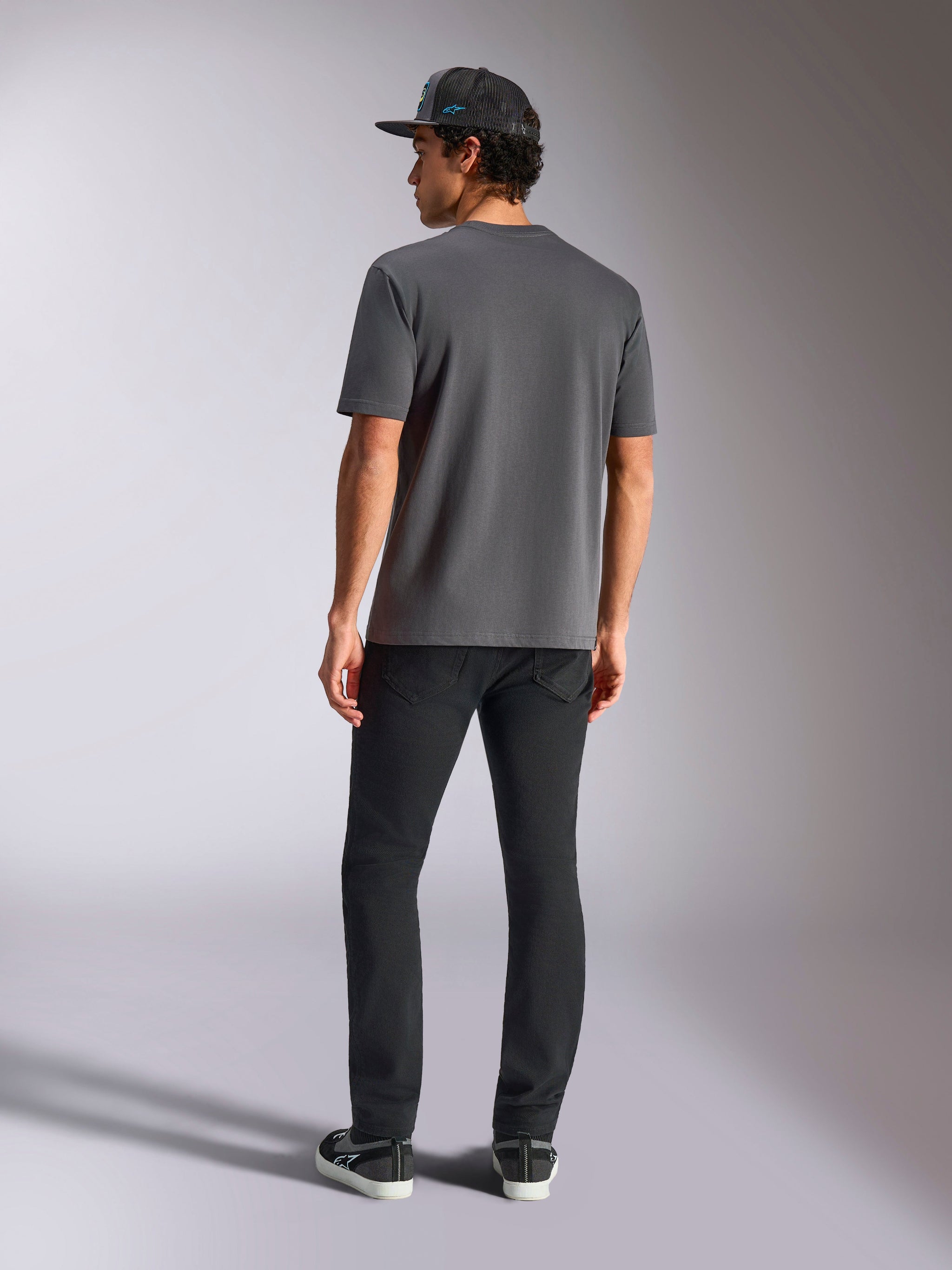 Alpinestars Blaze 2.0 CSF Tee, Charcoal Gray, Back View, Short Sleeve T-Shirt, worn with black pants and a black mesh cap, casual motorsport streetwear