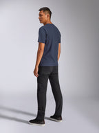 Alpinestars Blaze 2.0 CSF Tee, camiseta de manga corta, azul marino, vista posterior en modelo, combinada con pantalones negros y zapatillas, ropa urbana casual inspirada en el automovilismo