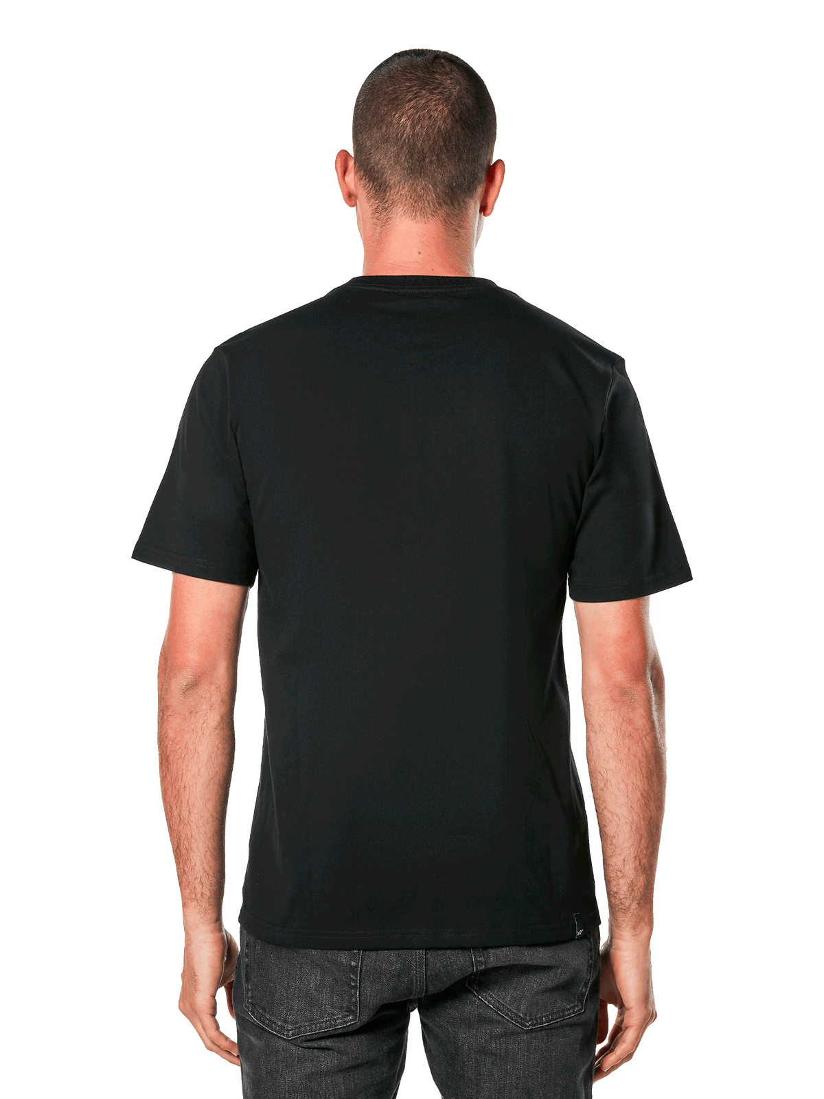 Camiseta Alpinestars Ride 4.0 CSF, vista posterior, camiseta negra de manga corta, ropa deportiva casual inspirada en el automovilismo, llevada por un hombre con vaqueros oscuros